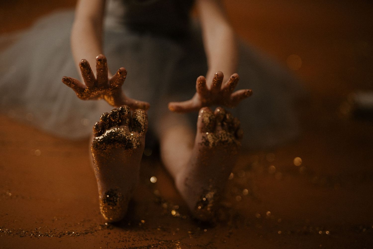 A sequence of hands emerging from darkness with dramatic lighting and splashing water creates a mysterious atmosphere.