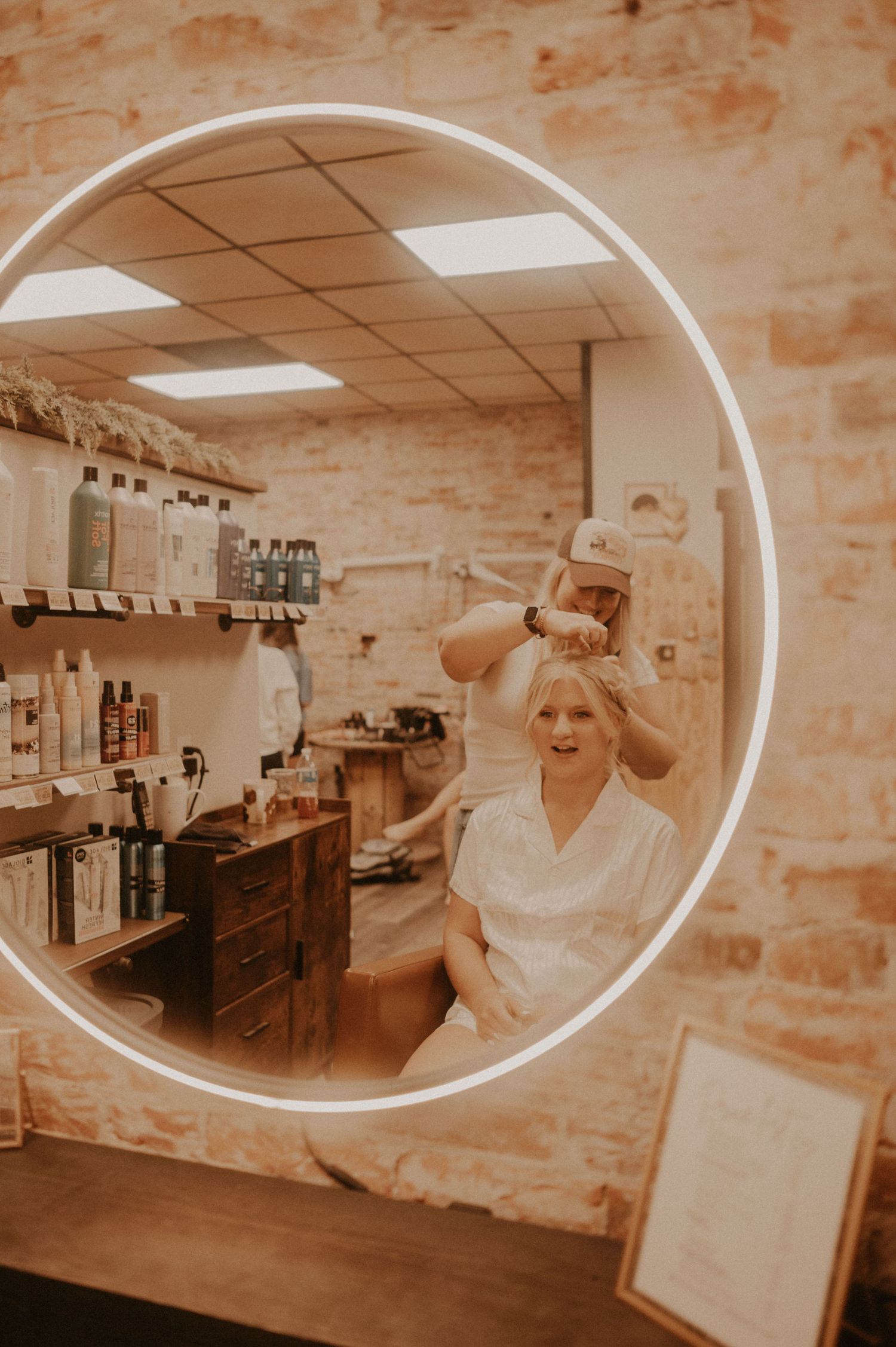 A series of sepia photographs showing a dressing room with brick walls and mirrors.
