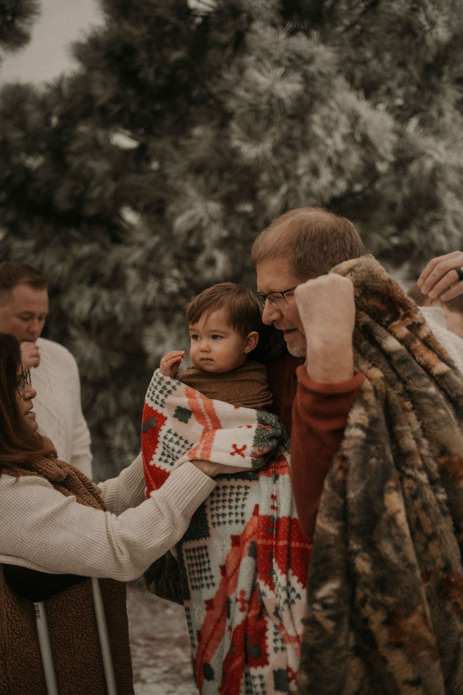 Family members in winter sweaters share playful peekaboo moments in a series of candid outdoor photos.