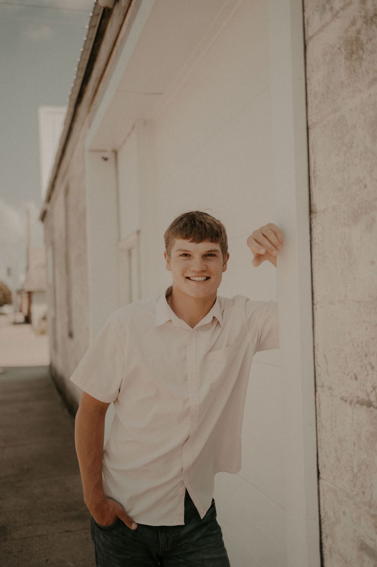 A series of connected photos showing a person in a white shirt against a light-colored wall.