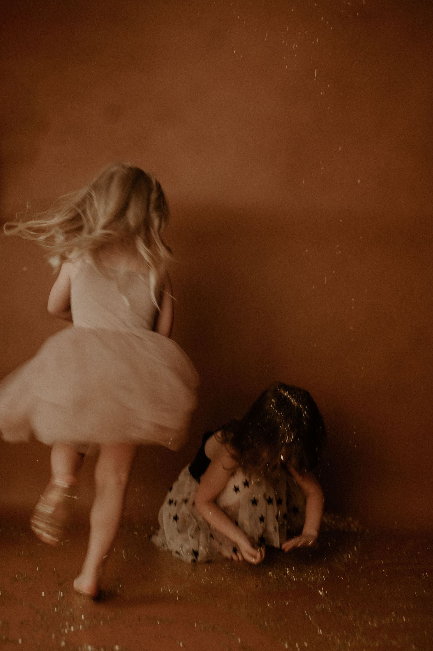A sepia-toned sequence of motion captures showing a child crawling and playing on the floor.