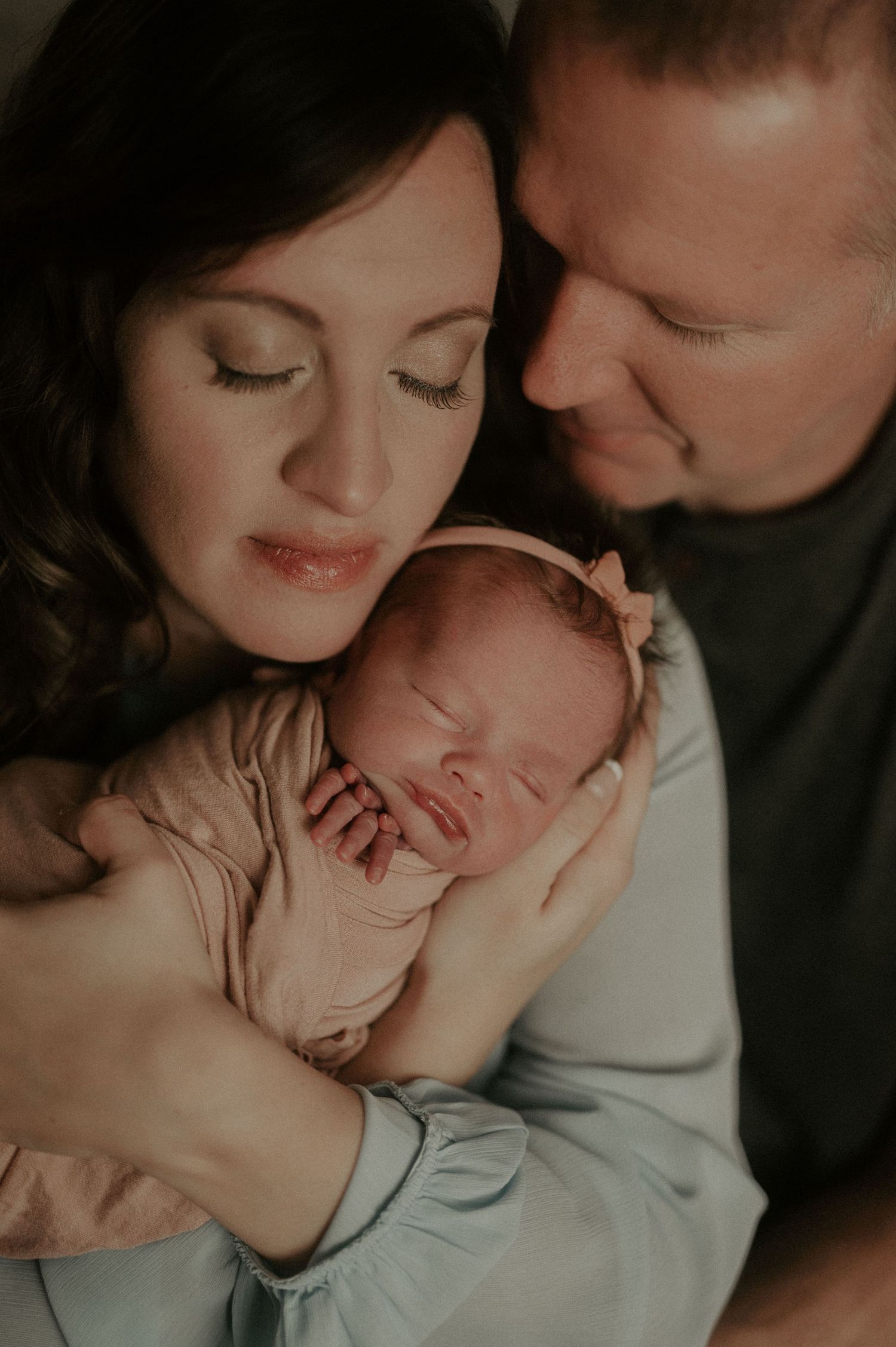 Romantic couple sharing intimate moments in a series of soft-lit close-up photographs.