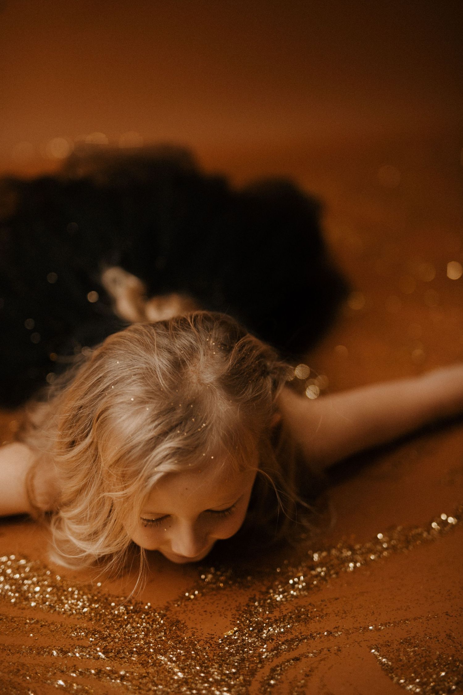 A series of artistic photographs showing blonde hair with glitter against a warm brown background in a dreamy sequence.
