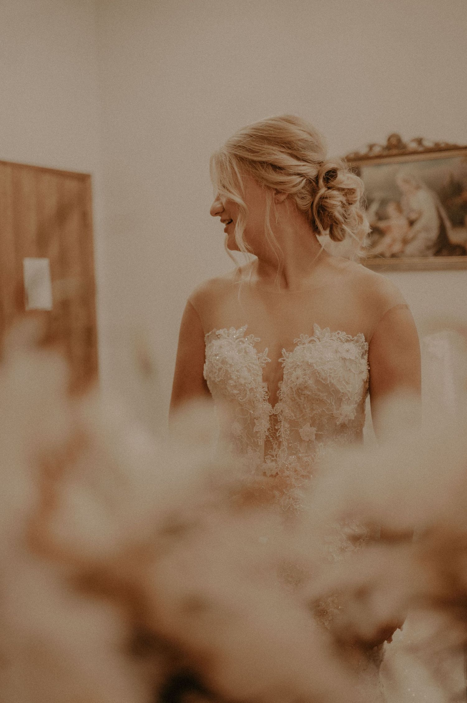 Close-up of intricate lace details on a white wedding dress.