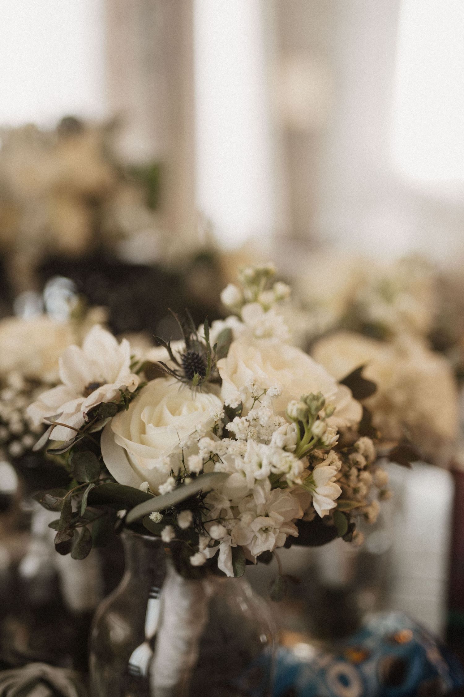 White floral arrangements with delicate blooms in soft focus.