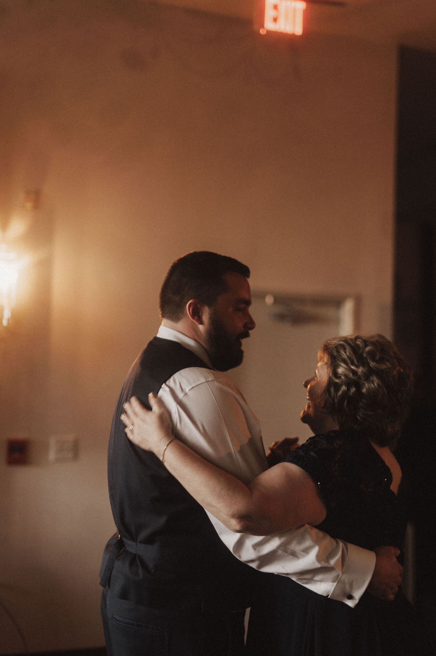 Couple embraces during their first dance at wedding reception.