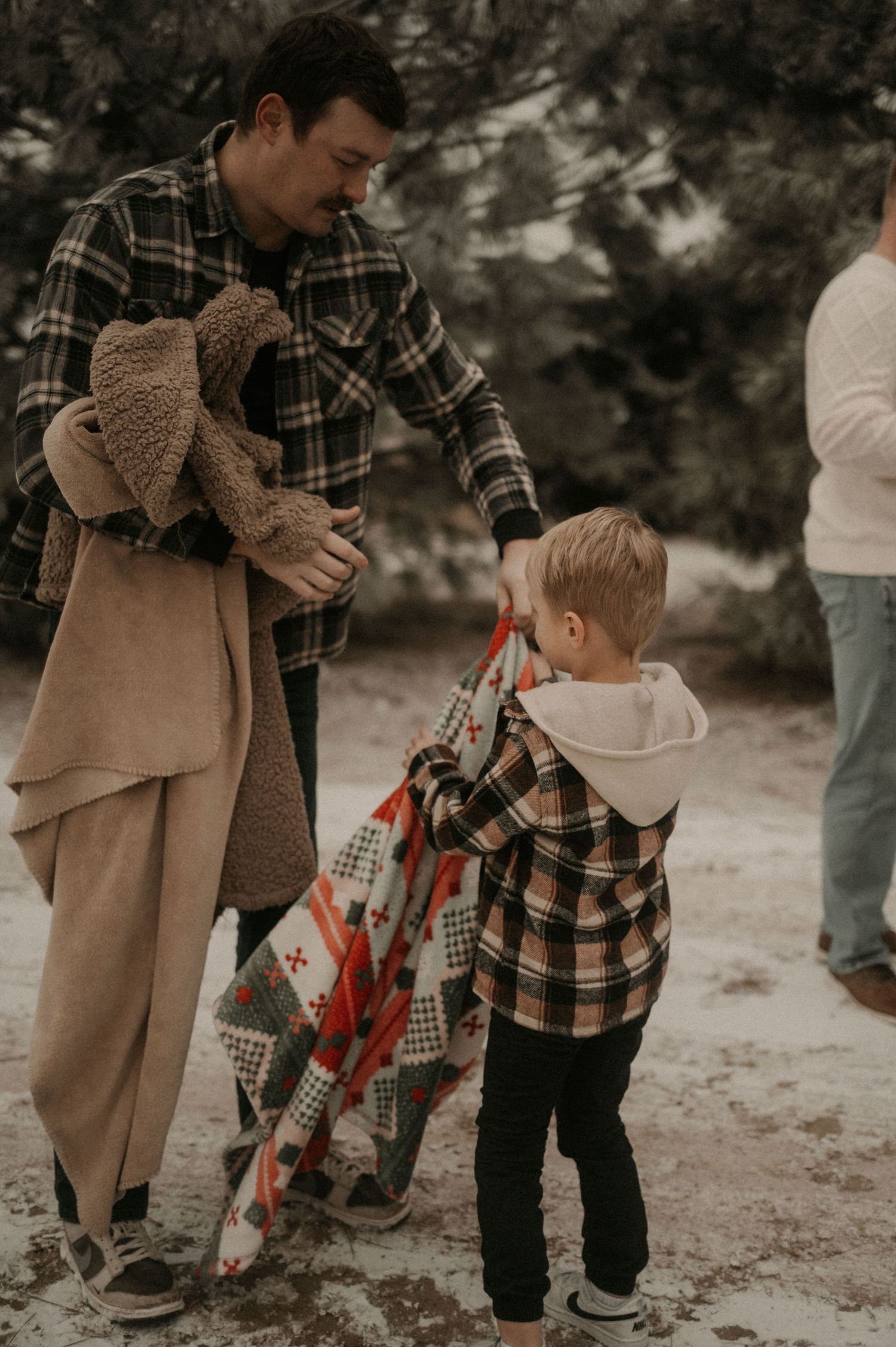 Parent and child in plaid and tan clothing share tender moments outdoors in a series of candid photographs.