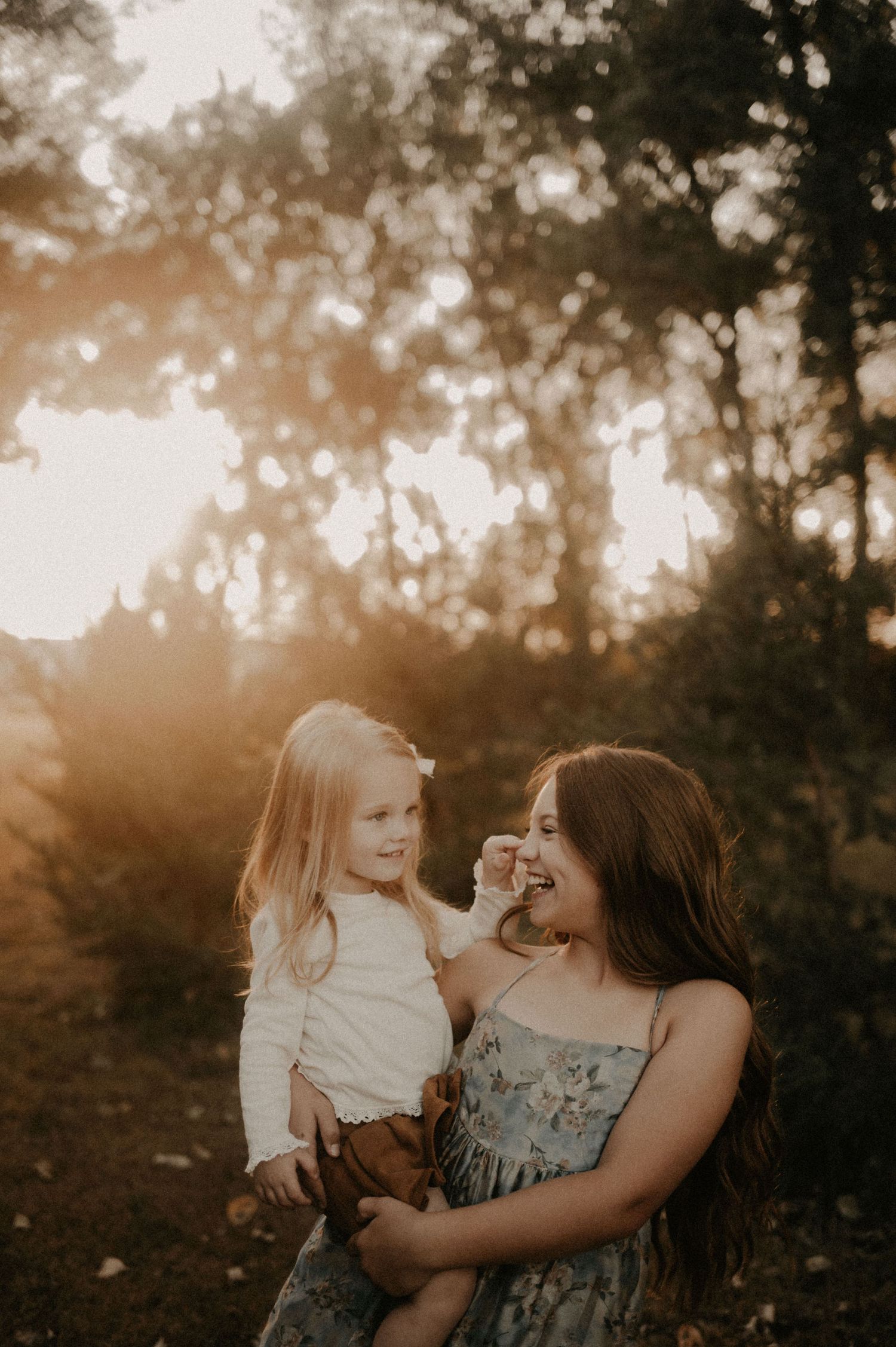 A joyful outdoor portrait session at sunset with warm golden lighting.