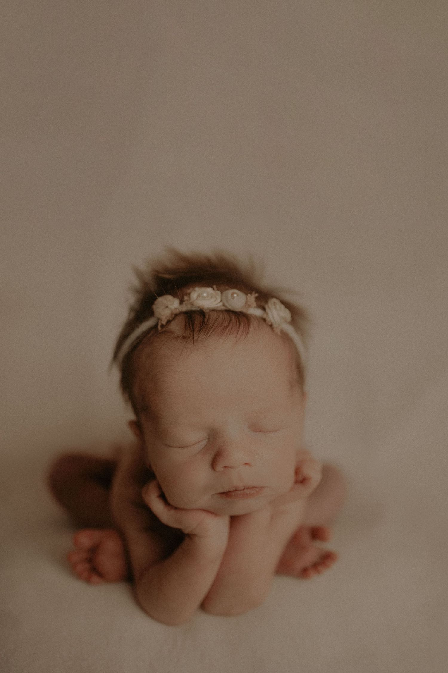 Peaceful sleeping newborn baby in artistic studio lighting.