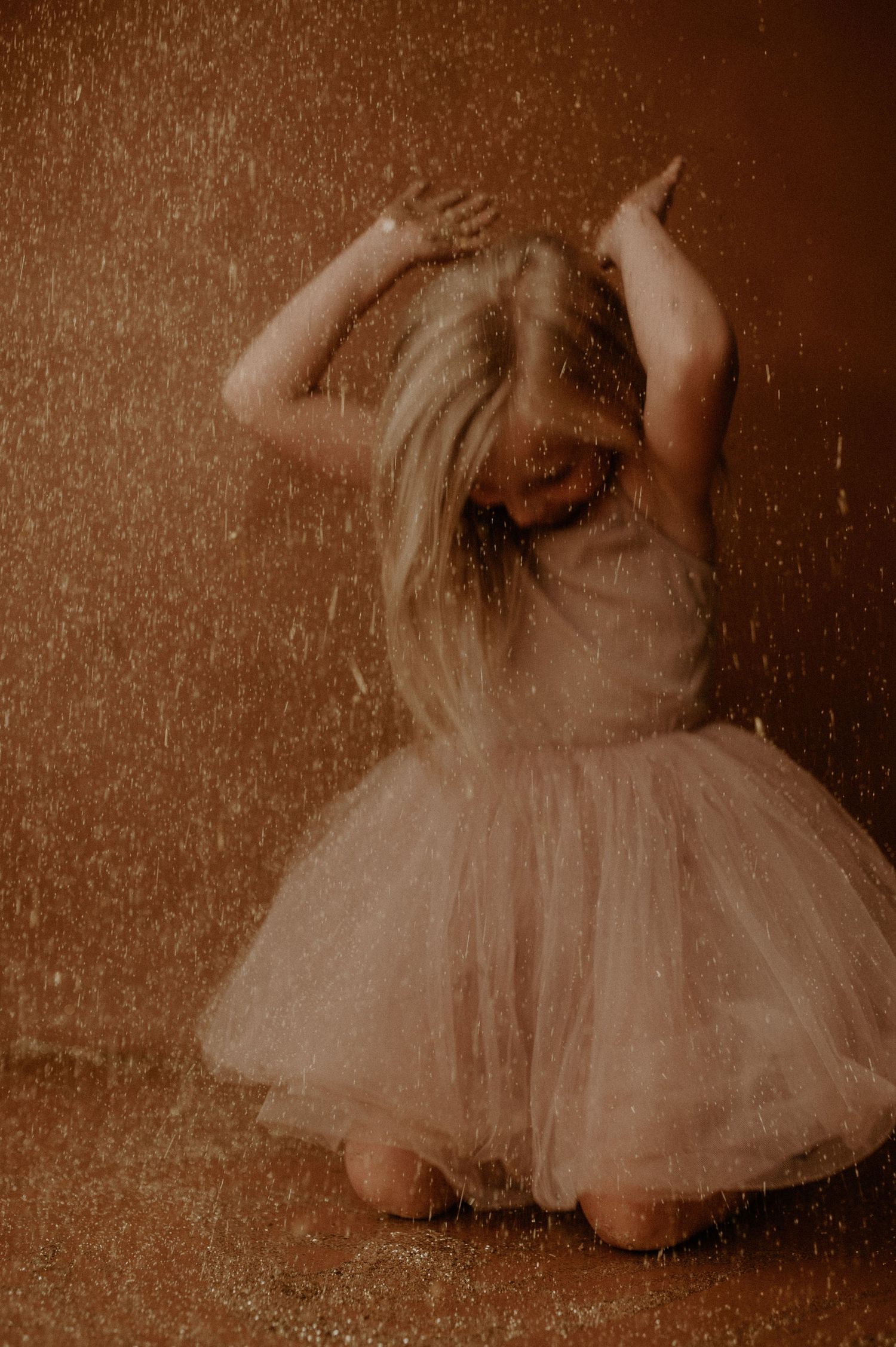 A sepia-toned sequence of dance movements showing a figure in a tulle dress performing graceful ballet motions.
