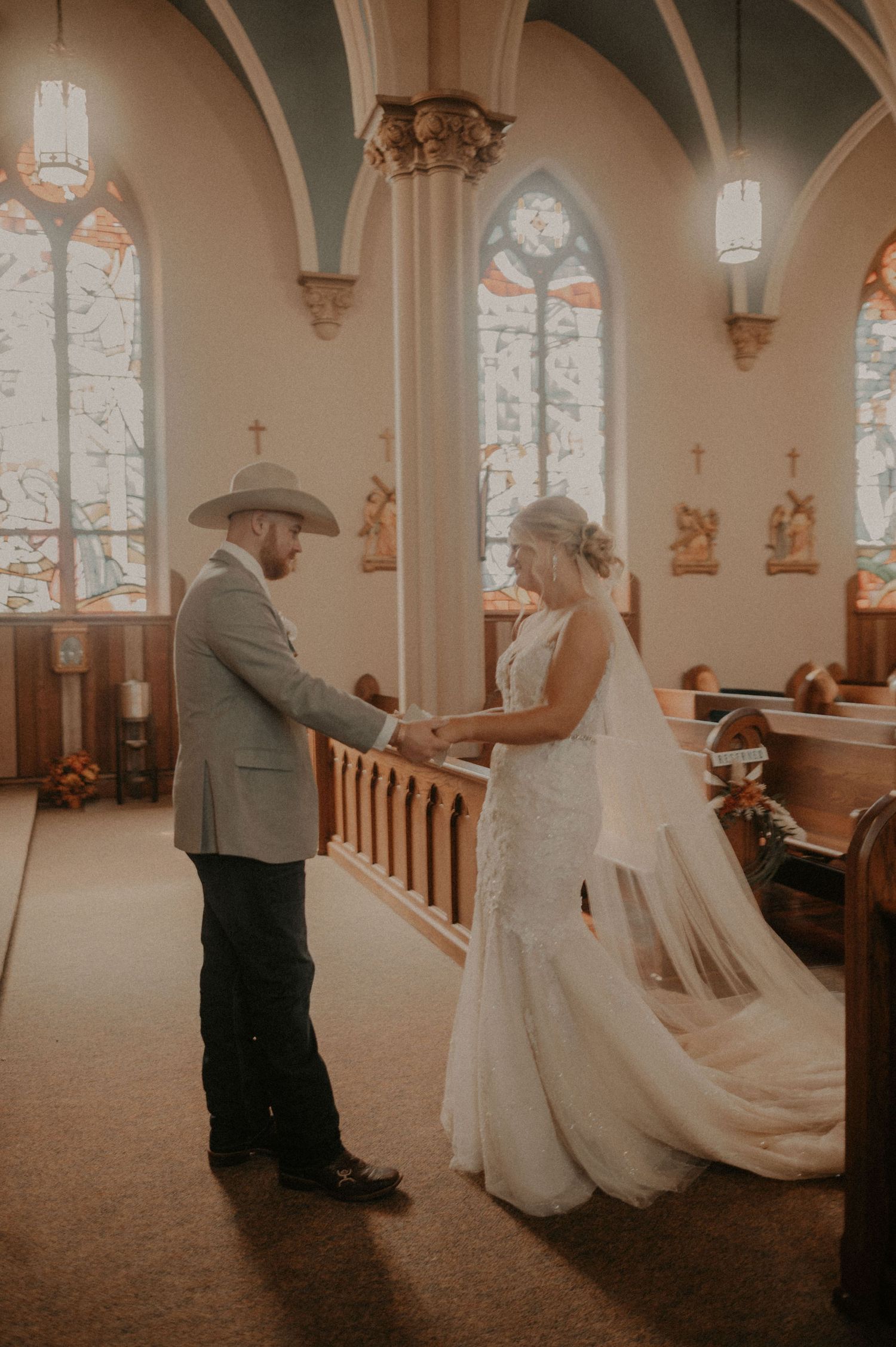 Wedding couple dancing in a historic church sanctuary with dramatic architectural features.