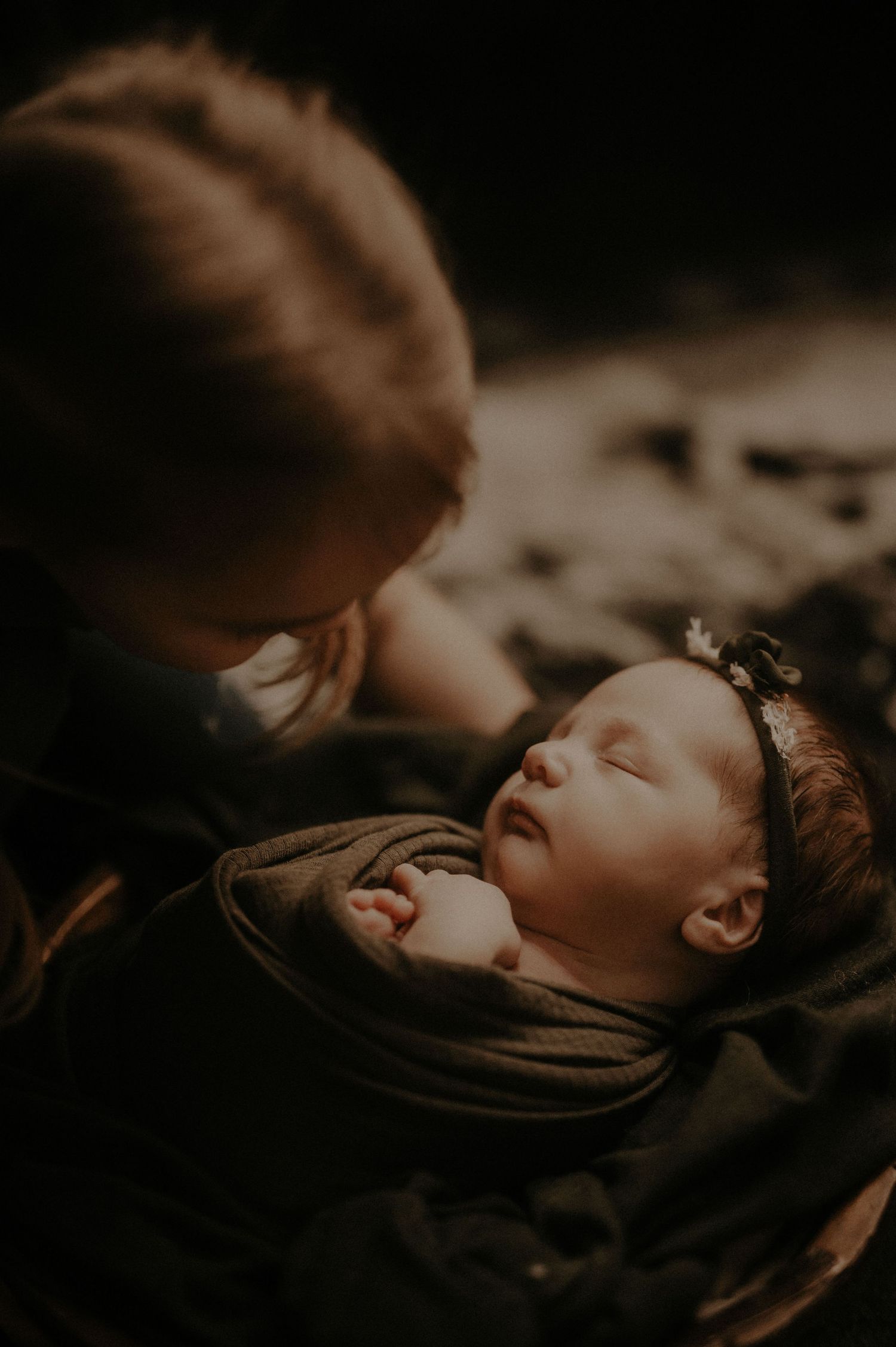 Dramatic close-up portrait with soft lighting and shadows creating an intimate atmospheric mood.