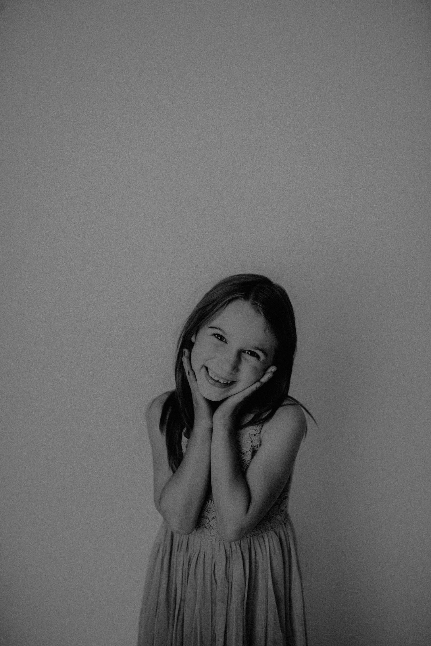 A black and white photo series showing someone expressing different emotional states and poses against a plain background.