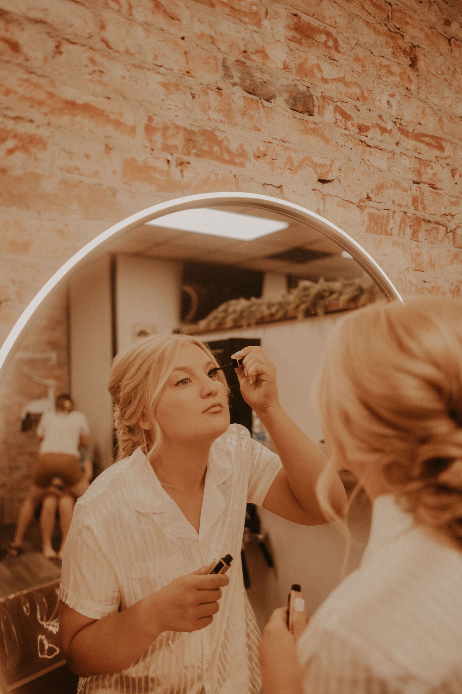 A sepia-toned collage of wedding preparation moments showing styling and getting ready in a rustic brick setting.