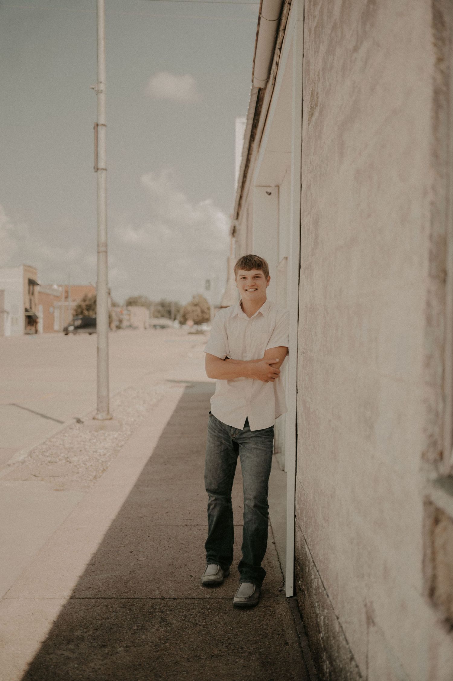 A series of minimalist photos showing parts of a person standing against a concrete wall in natural lighting.