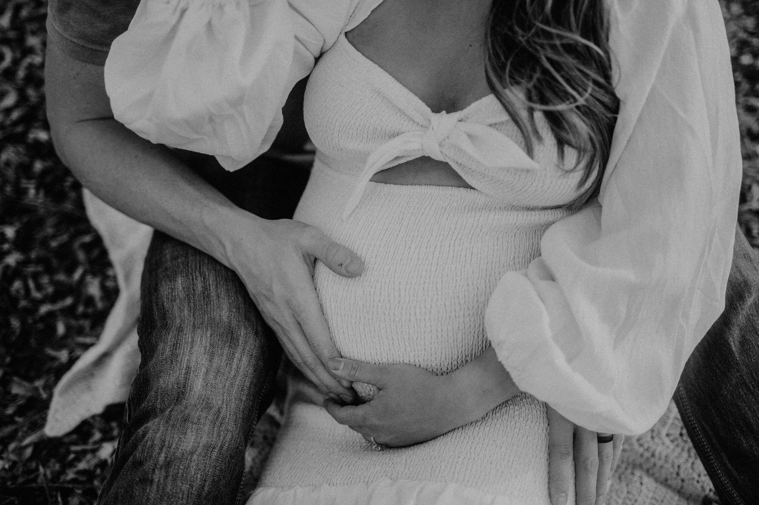 Romantic outdoor maternity photoshoot in a white flowing dress.