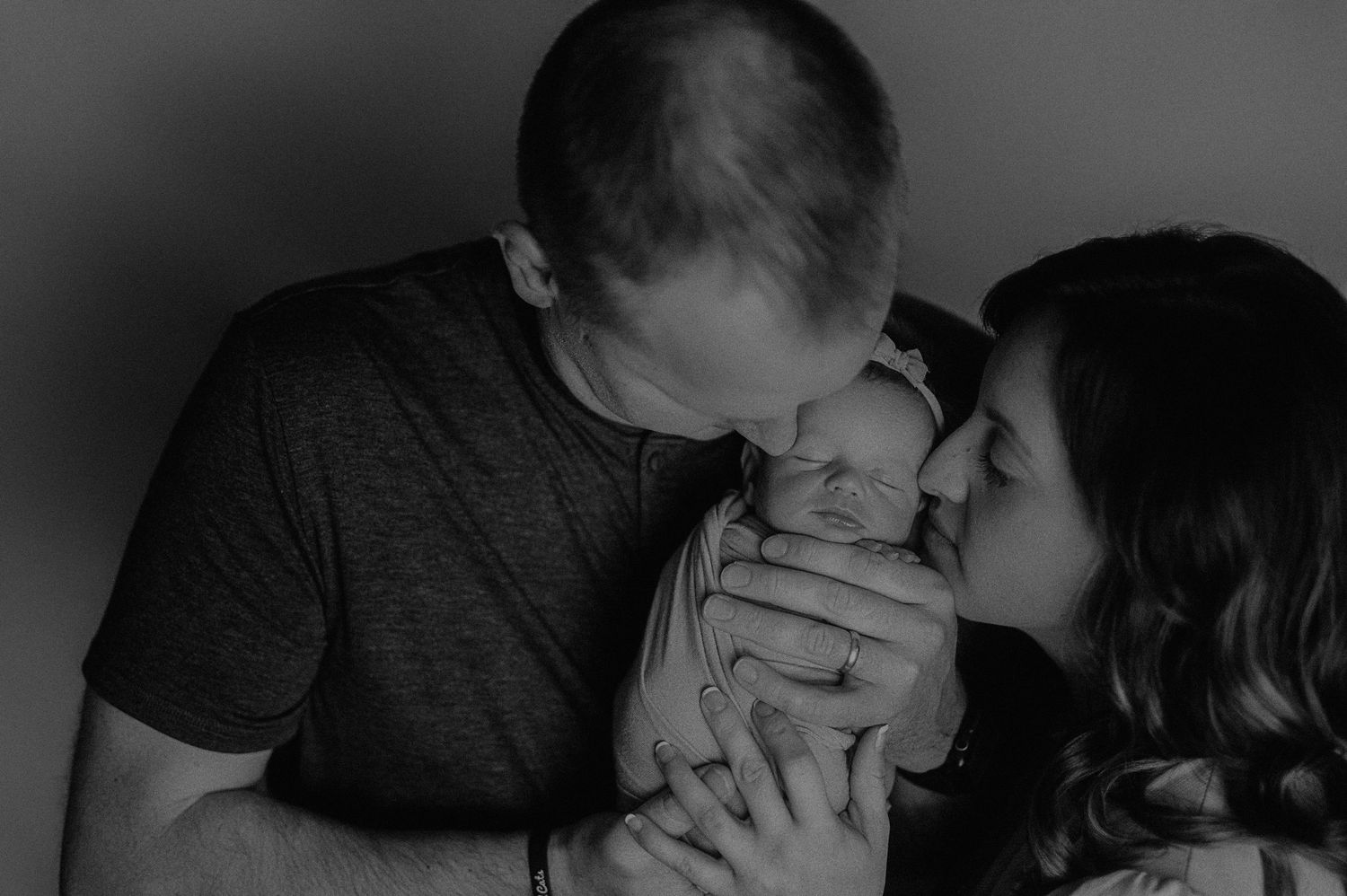 Series of intimate black and white family moments captured in soft lighting.