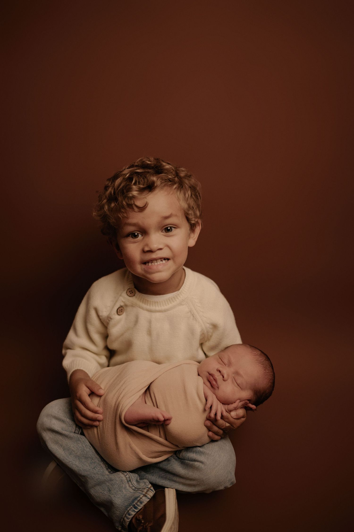Heartwarming studio portrait capturing tender moments with a newborn.