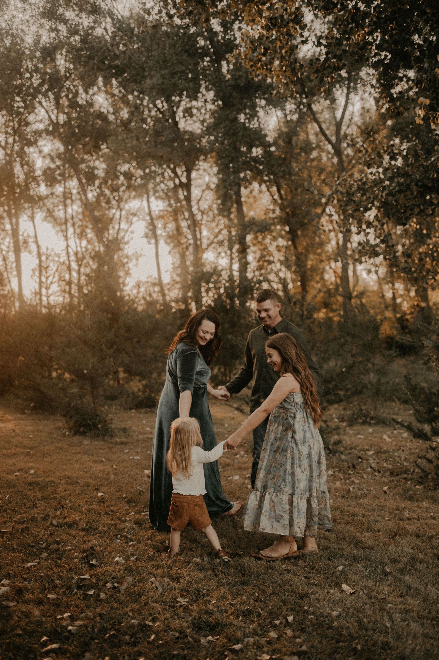 Family portrait session in autumn woods with warm earth tones.