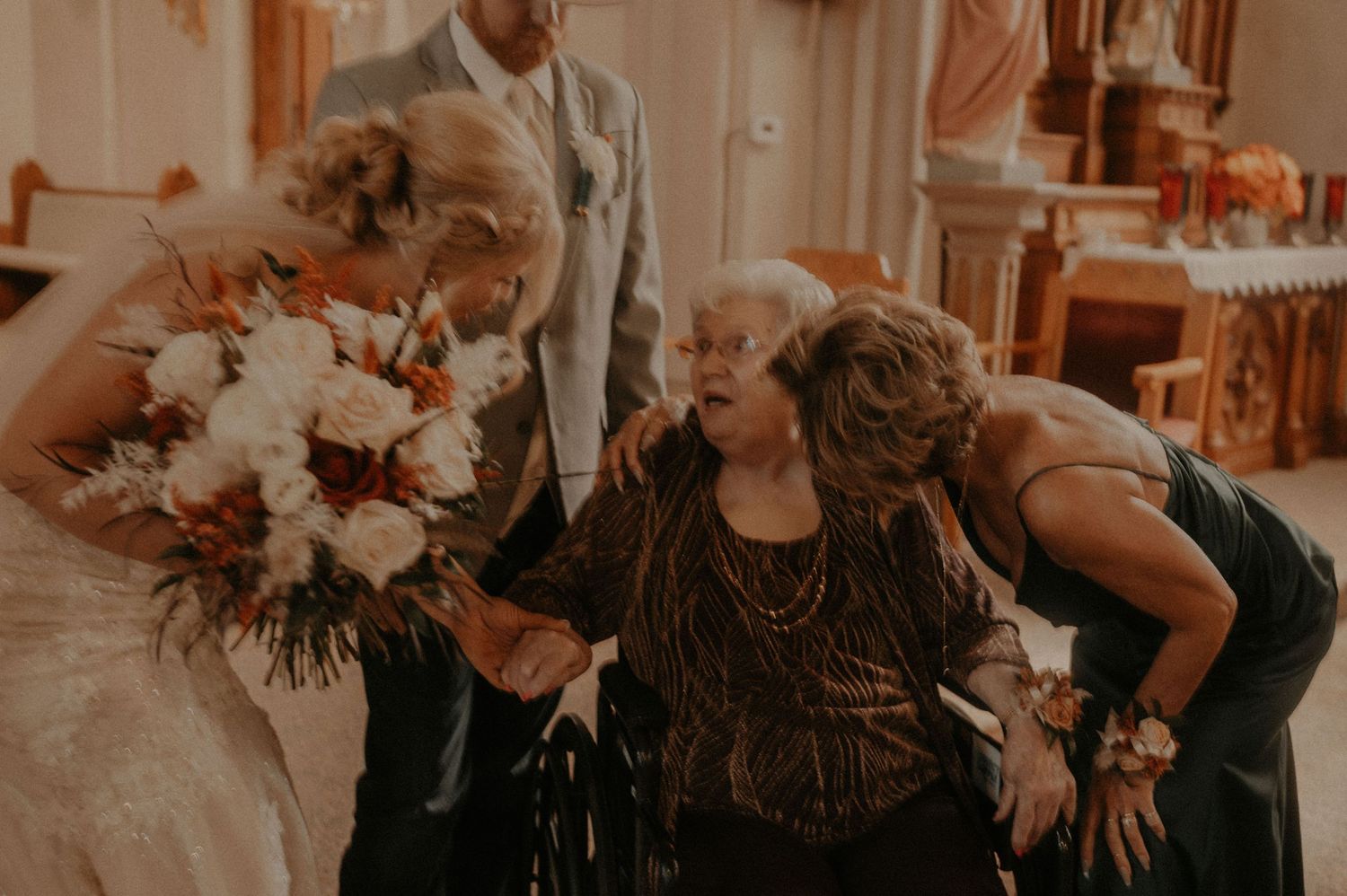 Emotional wedding moments captured in warm tones inside a historic church sanctuary.