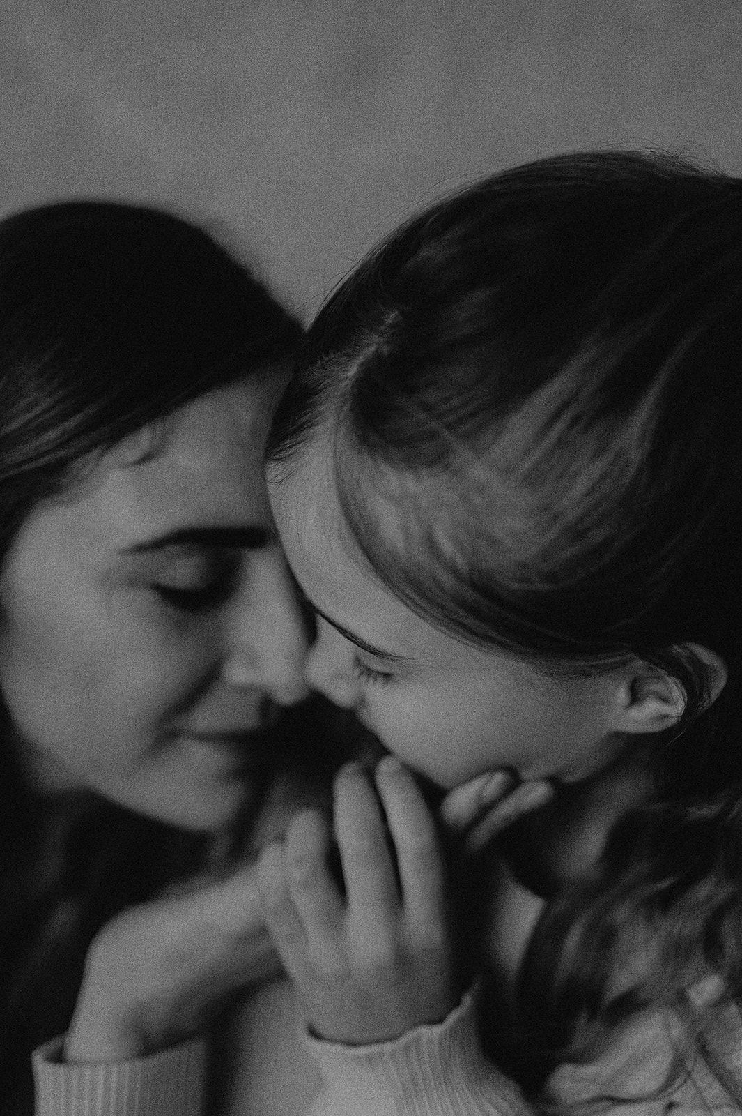 A series of black and white photographs showing tender intimate moments between two people in close proximity.