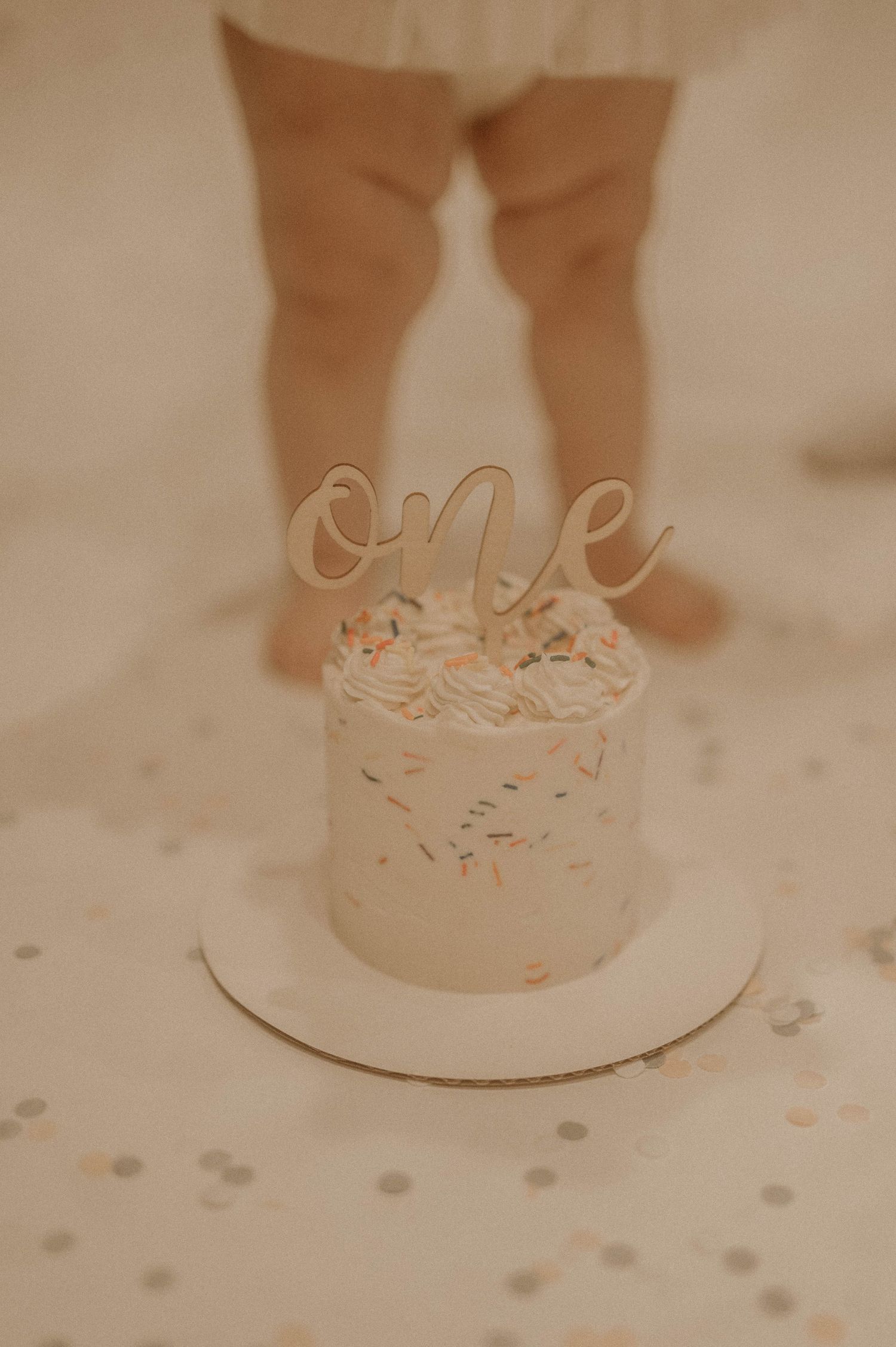 A sequence of close-up shots showing confetti and decorative elements on a light-colored surface.