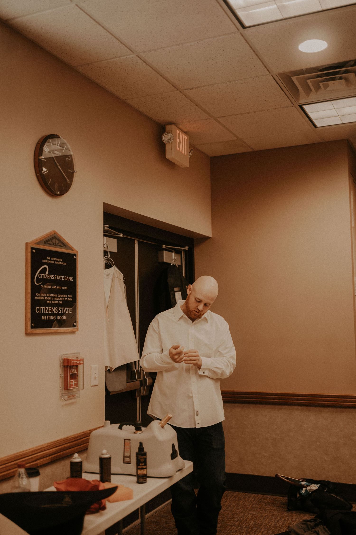 A sequence of candid moments showing preparations in a warmly lit room with white shirts and casual attire.