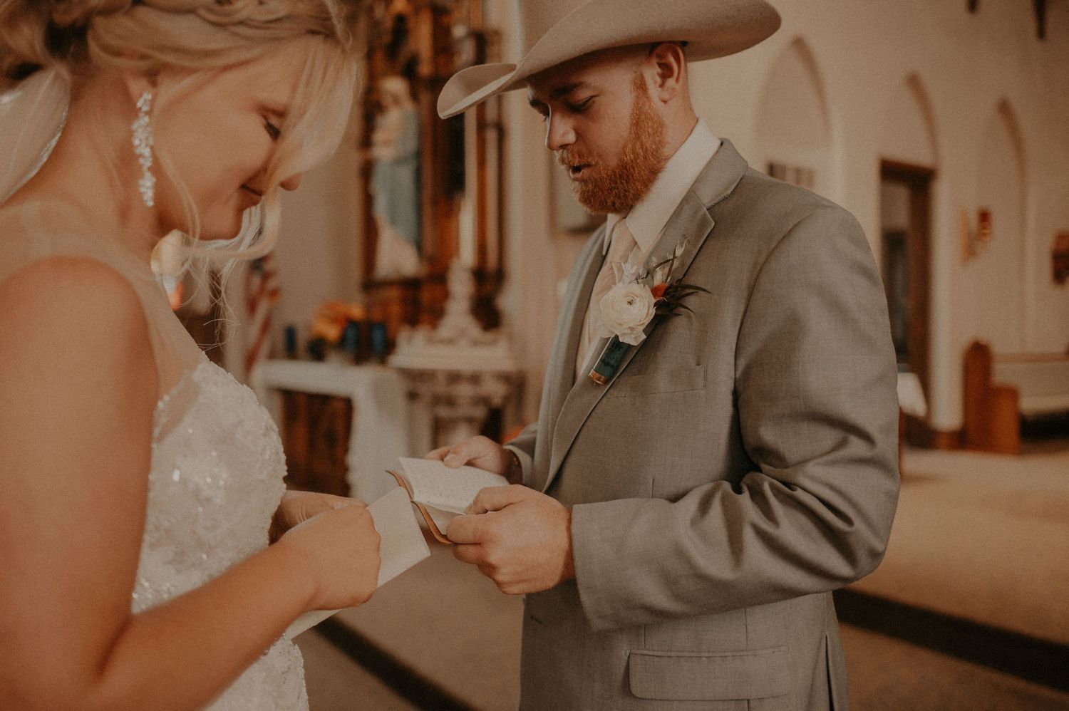 A couple in wedding attire holds hands during a romantic ceremony.