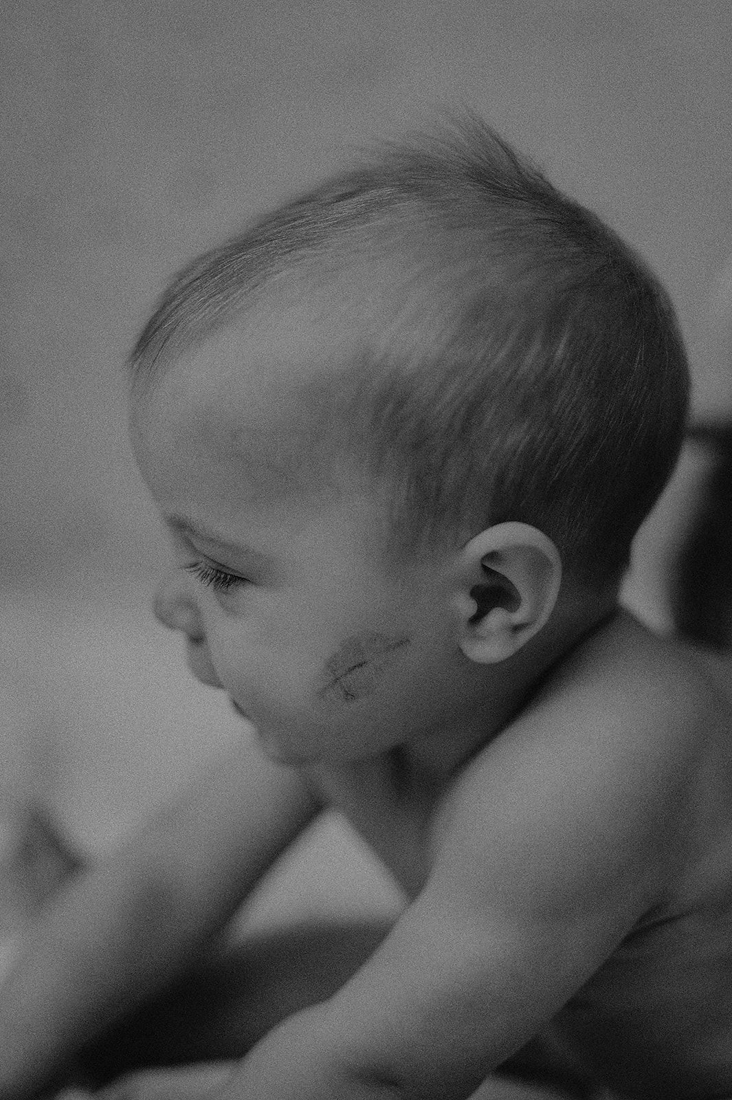 Black and white profile shots of a baby's face showing different angles and expressions.