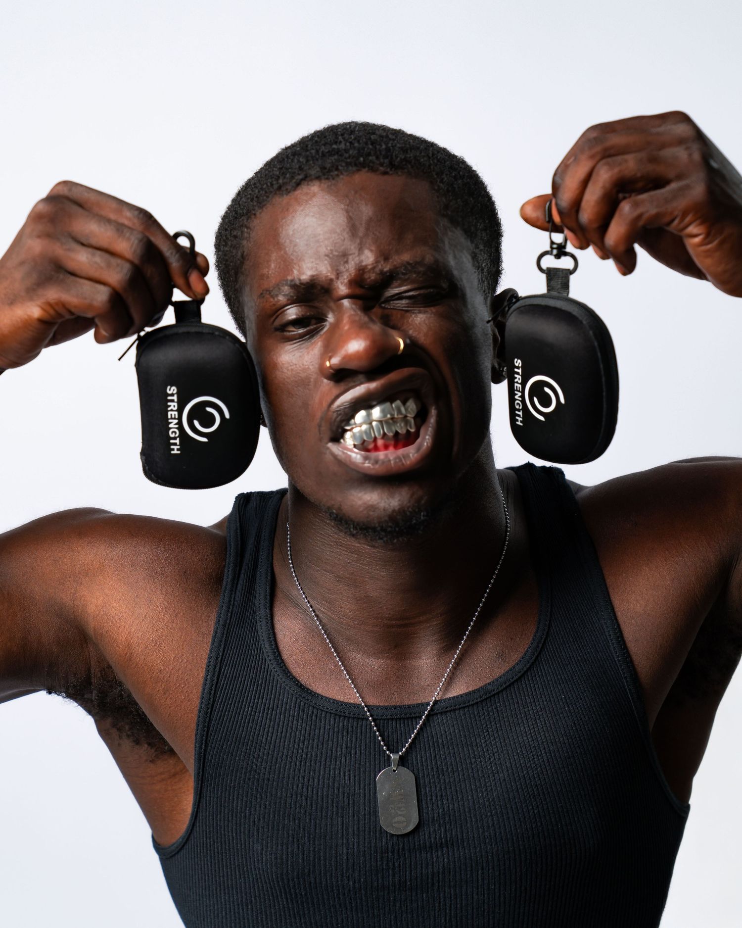 A person wearing a black tank top and dog tags shows different facial expressions. Boston MA photographer, Malden MA and Greater Boston.