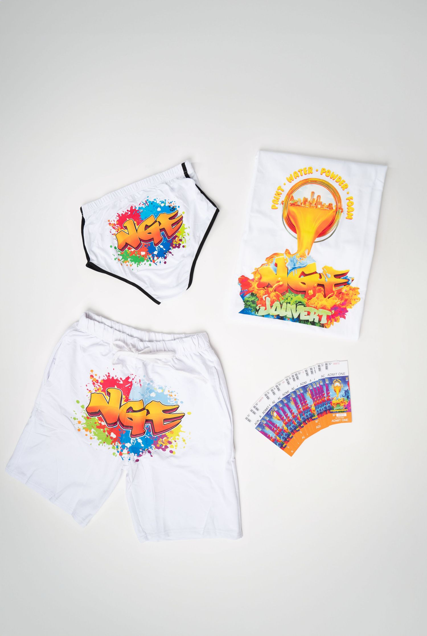 White t-shirt and shorts with colorful paint splatter design displayed in multiple angles against light background. Boston MA photographer.