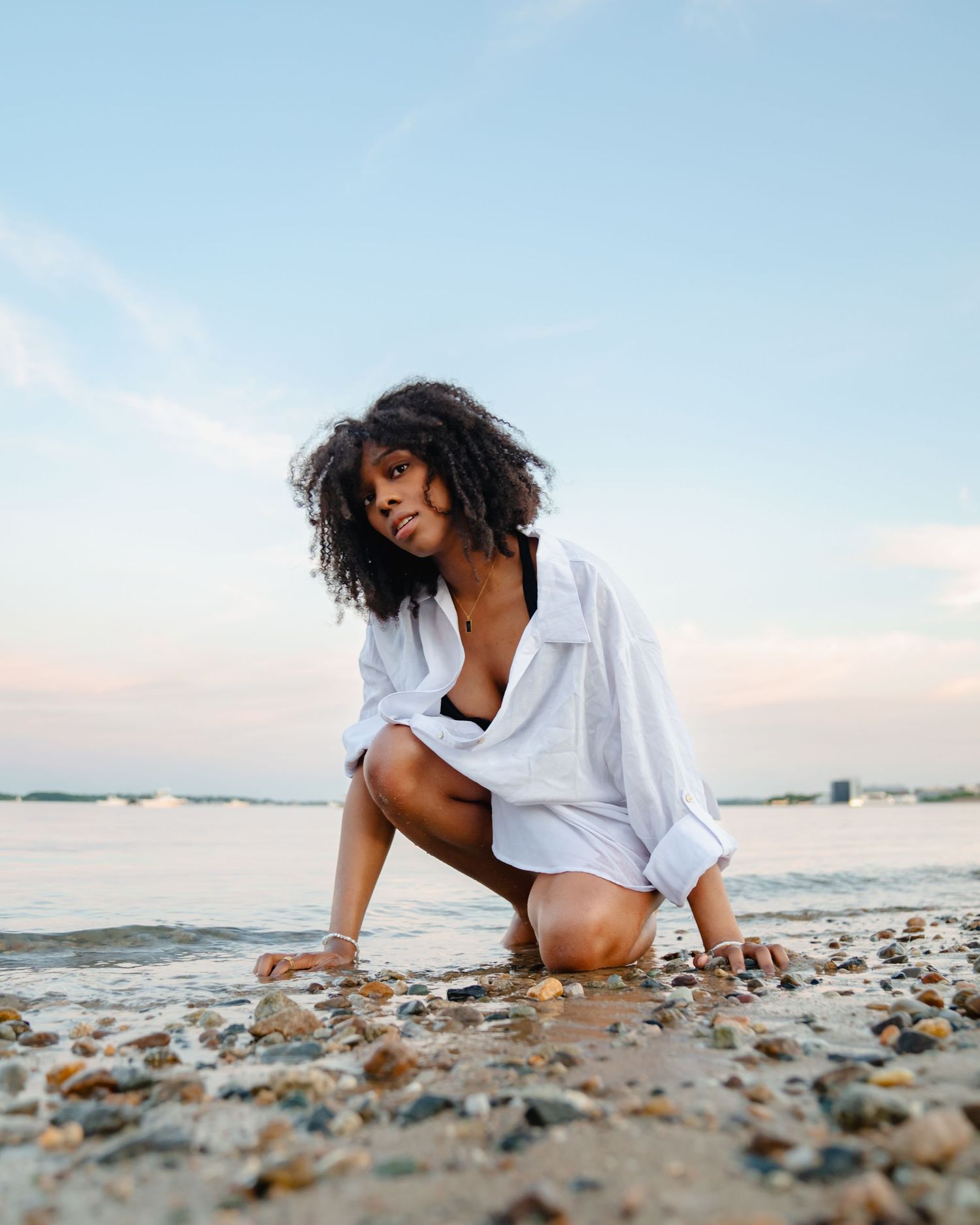 Artistic beach photoshoot at sunset with seashells and waves in the background. Boston MA photographer, Malden MA and Greater Boston Area.