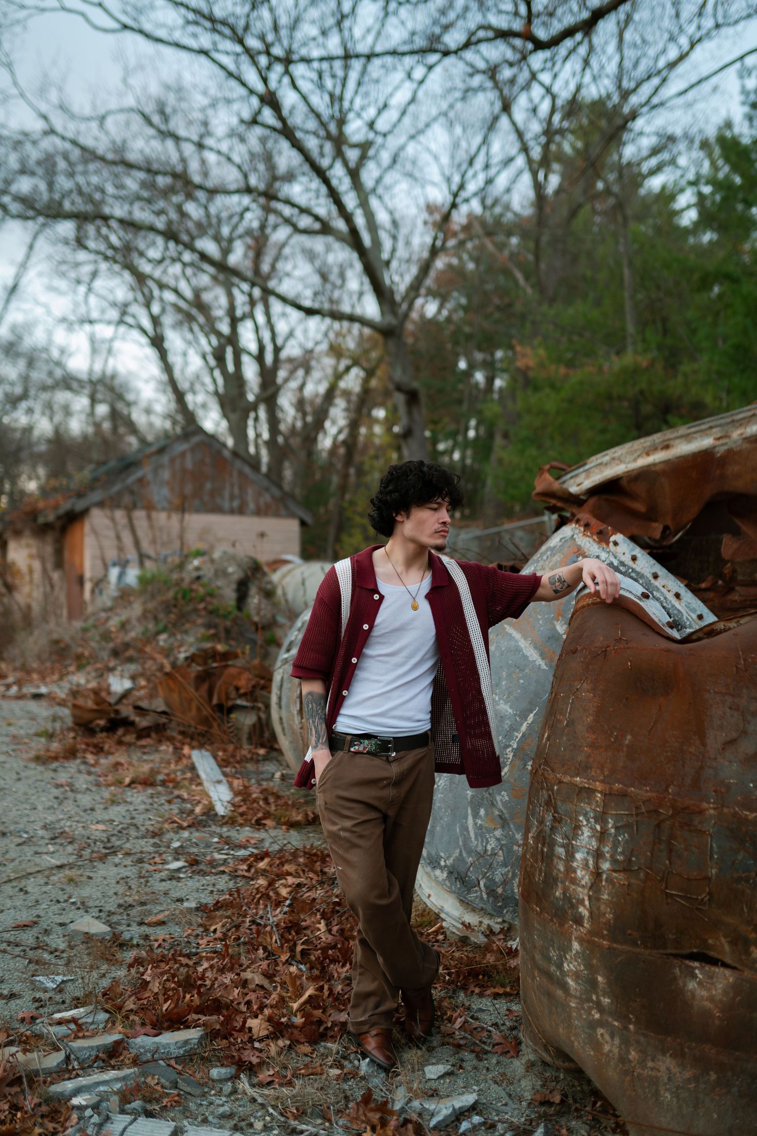 Artistic poses against rustic metal barrels in autumn setting with fallen leaves. Boston MA photographer, Malden MA and Greater Boston Area.