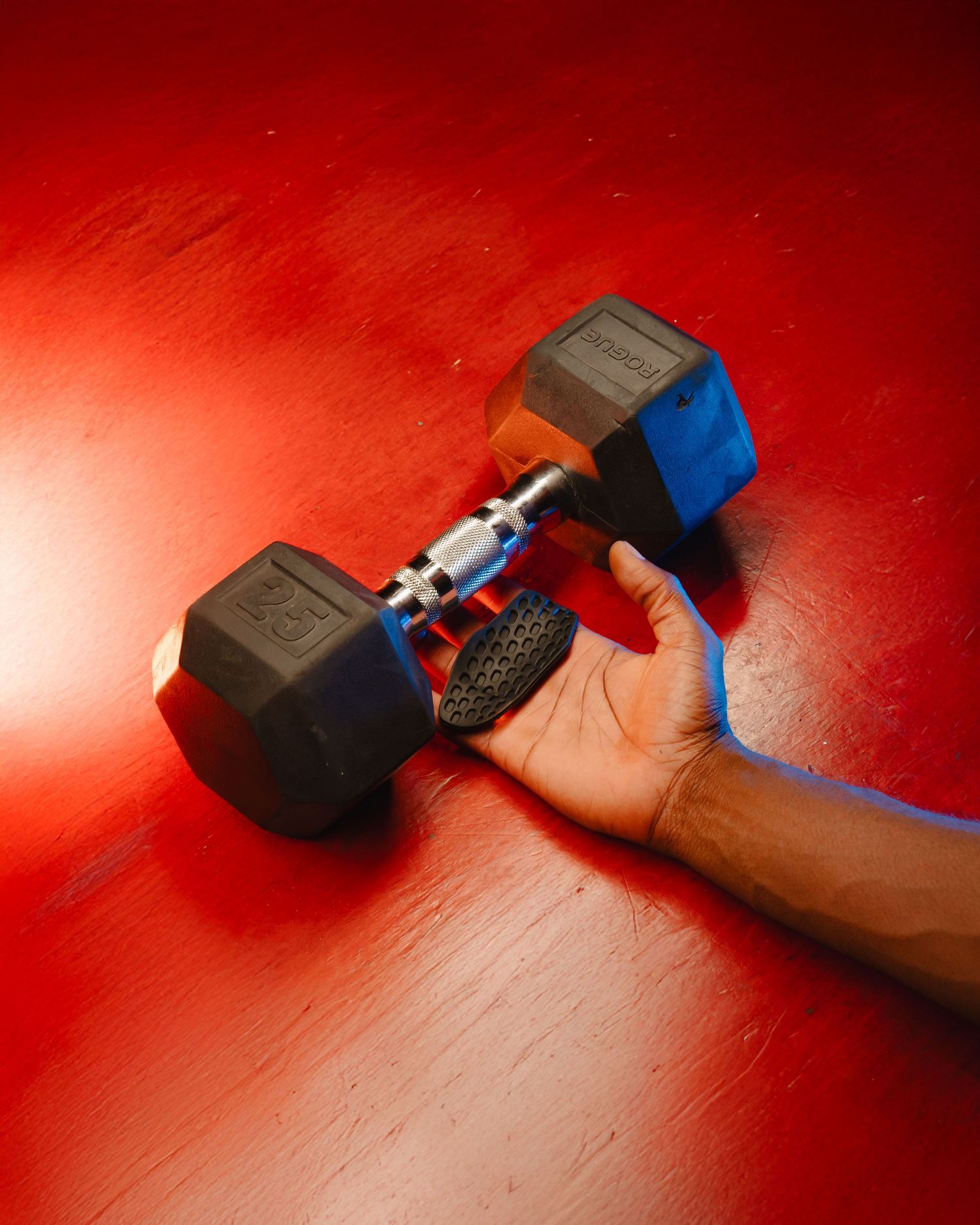 Hand holding a grip protector under a 10 pound gym weight. Boston MA photographer, Malden MA and Greater Boston.
