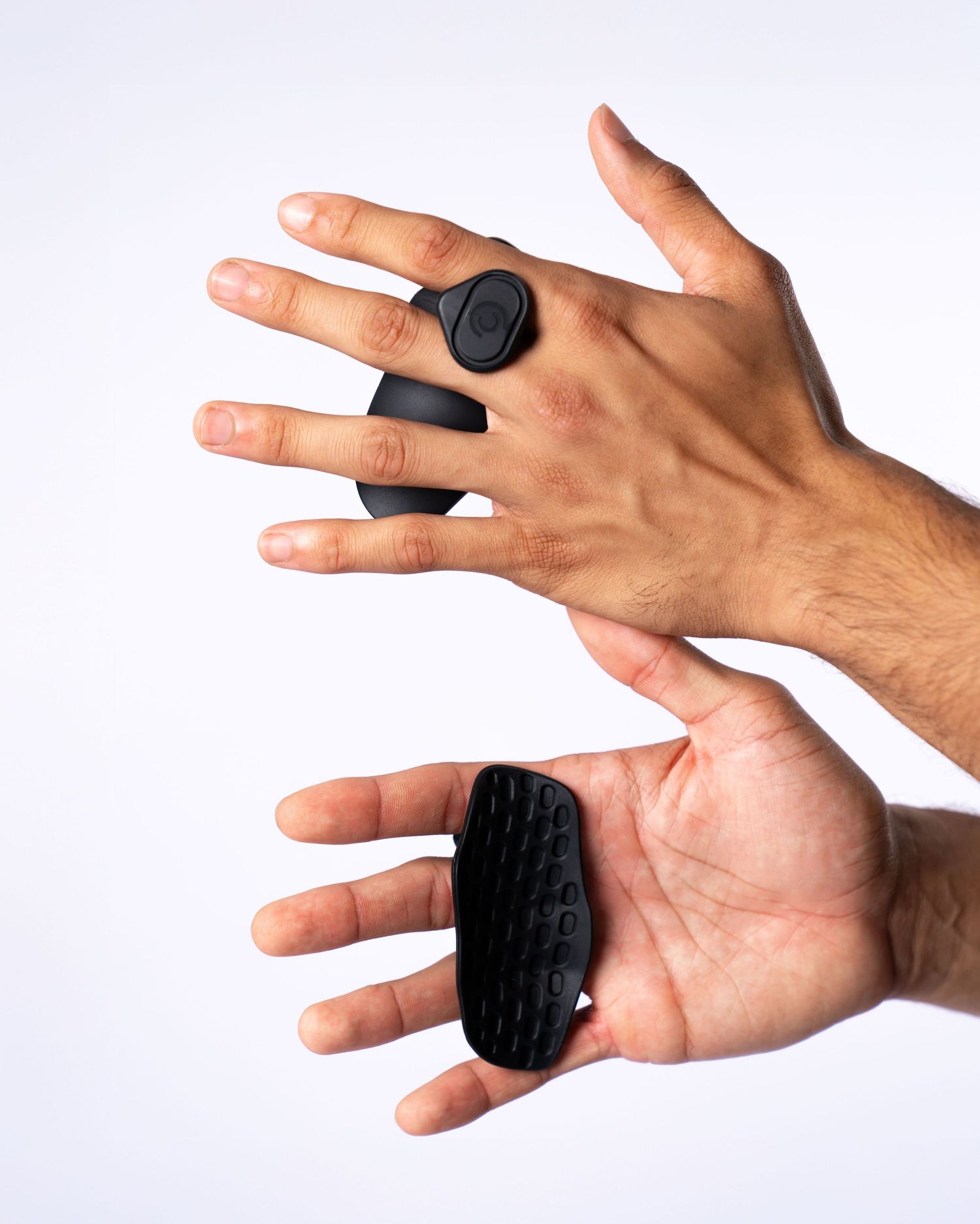 Two hands holding black grip protection against a white background. Boston MA photographer, Malden MA and Greater Boston.