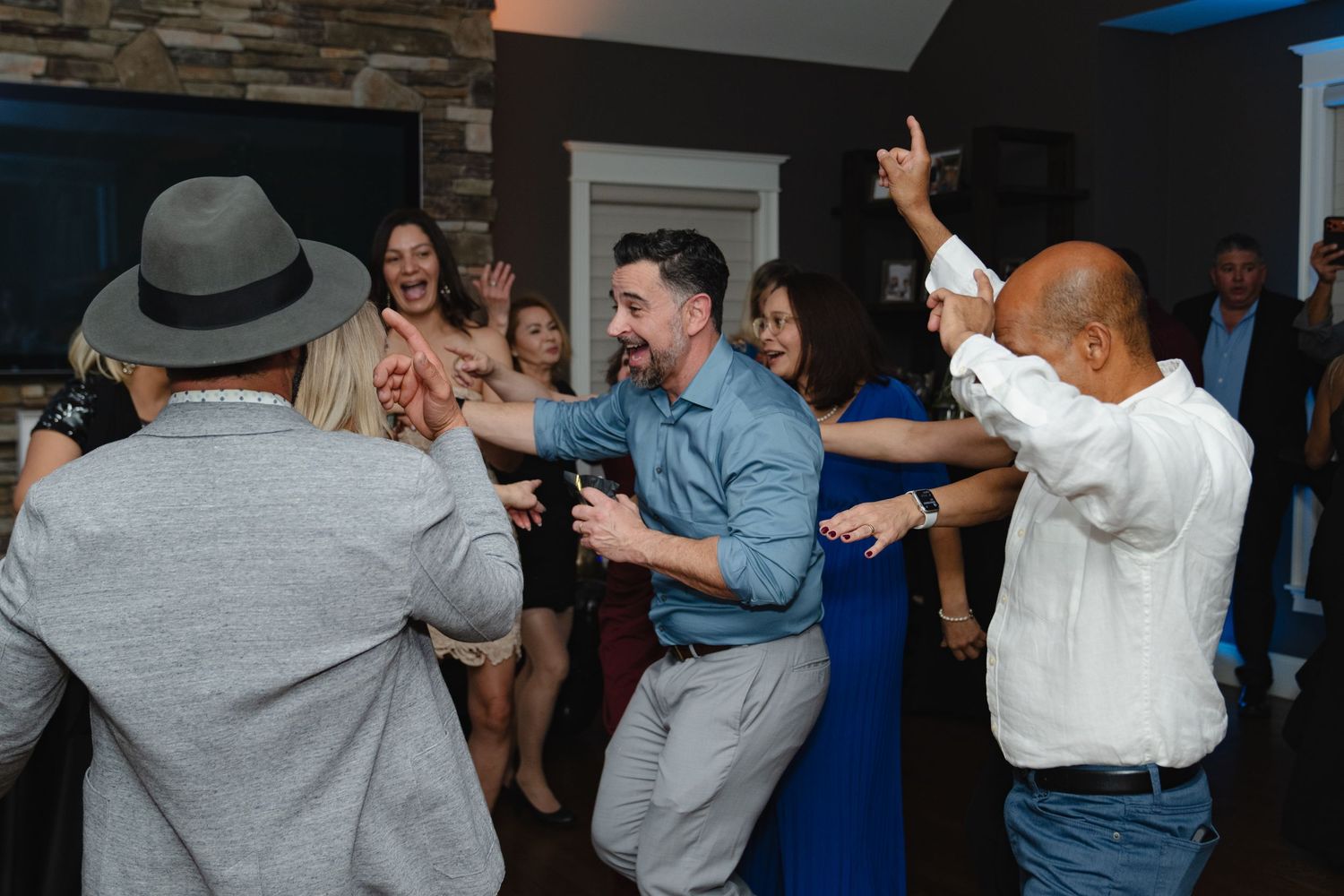 People dancing together at a social gathering in what appears to be a party or reception venue. Greater Boston Area photographer, Malden MA.