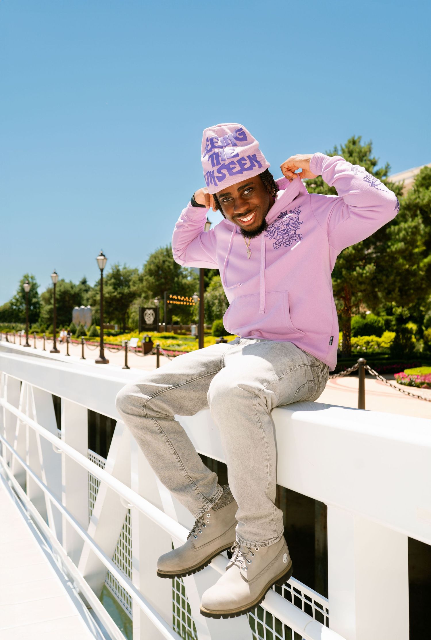 Action shots of skateboarding tricks on white railing wearing pink hoodie. Boston MA photographer, Malden MA and Greater Boston Area.