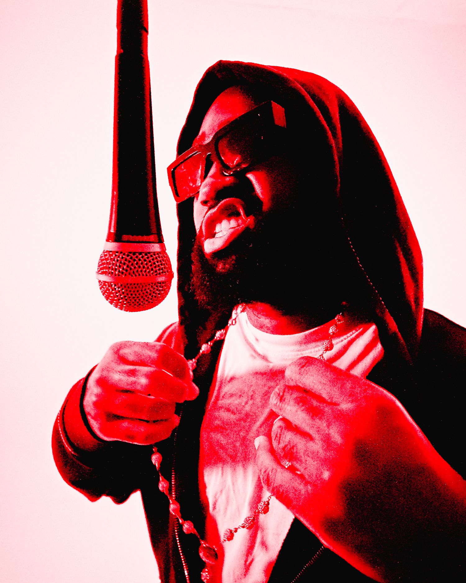 A performer in red lighting holds a microphone while singing passionately with head tilted back. Boston MA photographer, Malden MA.