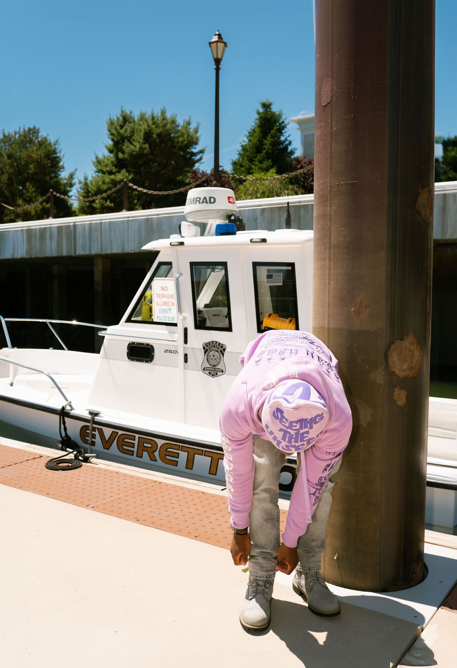 Urban skateboarding sequence near white police boat with pink street fashion. Boston MA photographer, Malden MA and Greater Boston Area.