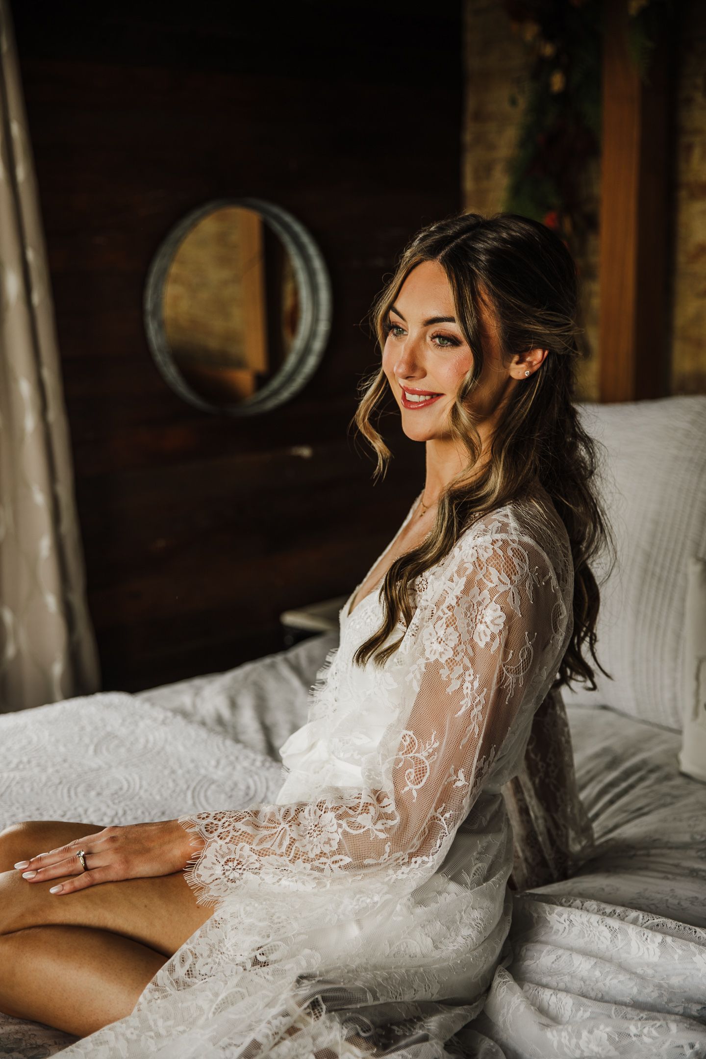Romantic boudoir photo session featuring delicate lace details and soft lighting on a white bed.