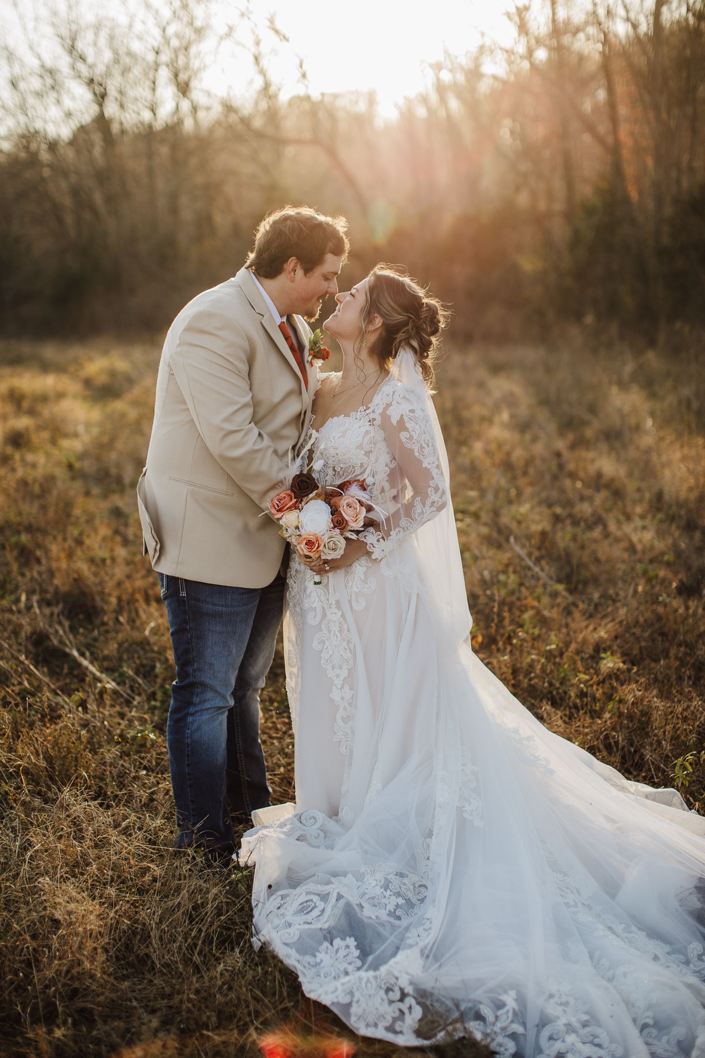 A romantic sunset wedding photoshoot in a golden field with a couple in a white dress and casual attire.