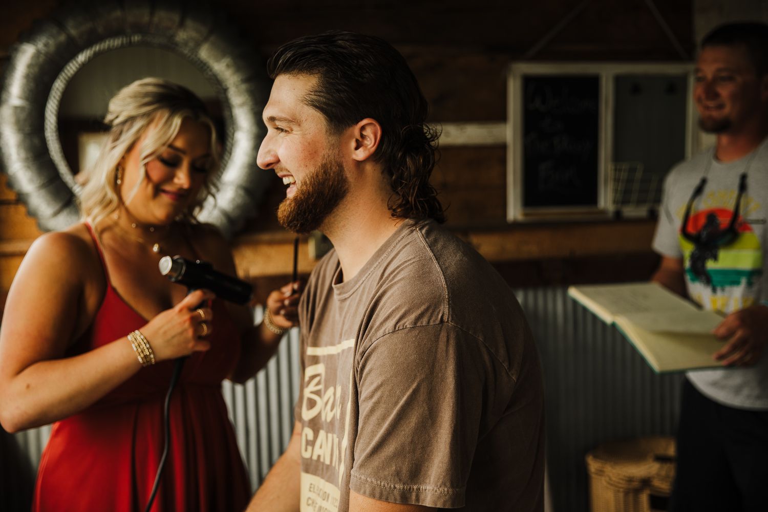 Couple shares an intimate moment during sunset in a warm, golden-lit setting.