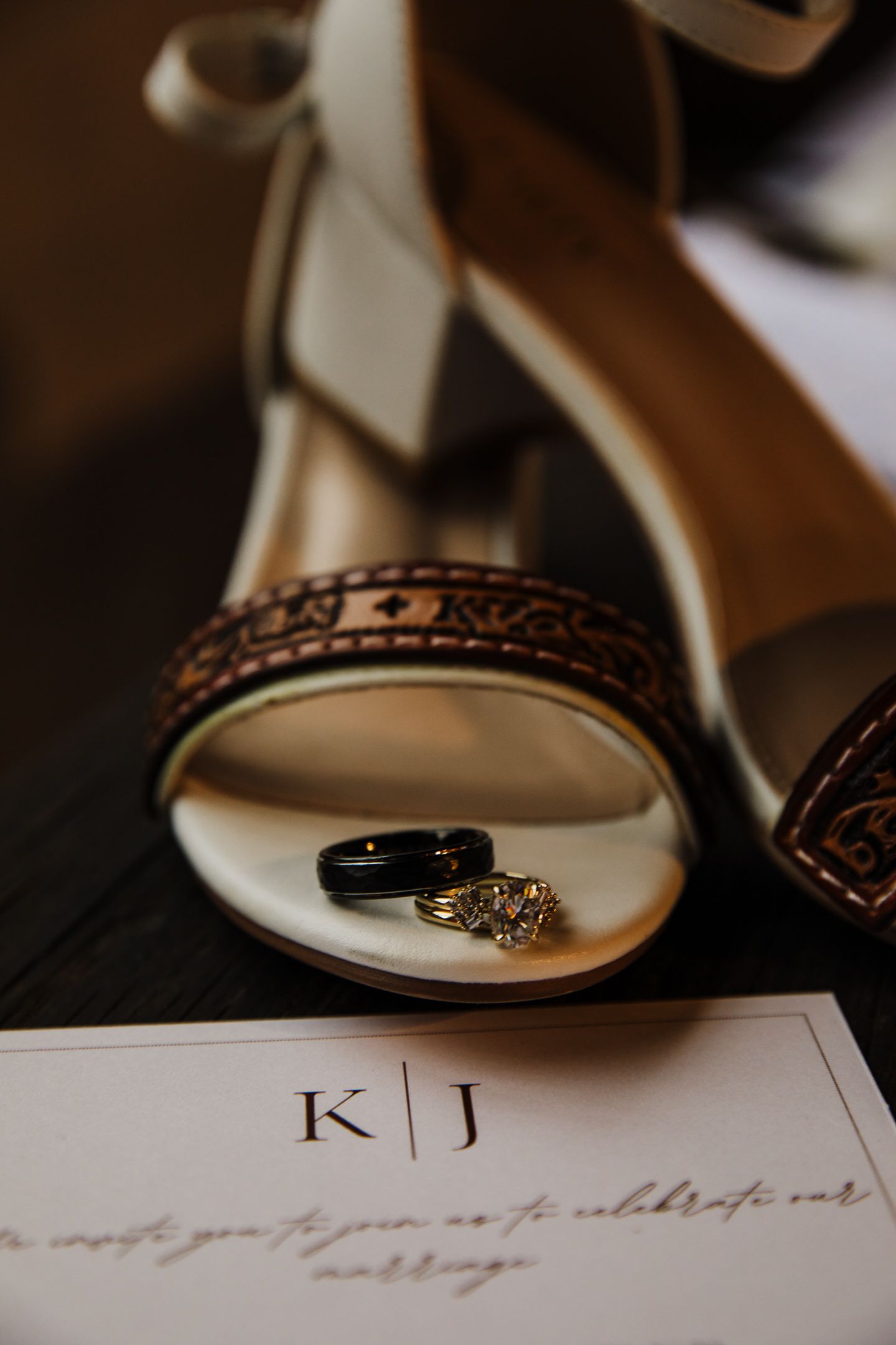 Wedding rings and details artistically arranged on elegant stationery with monogram.