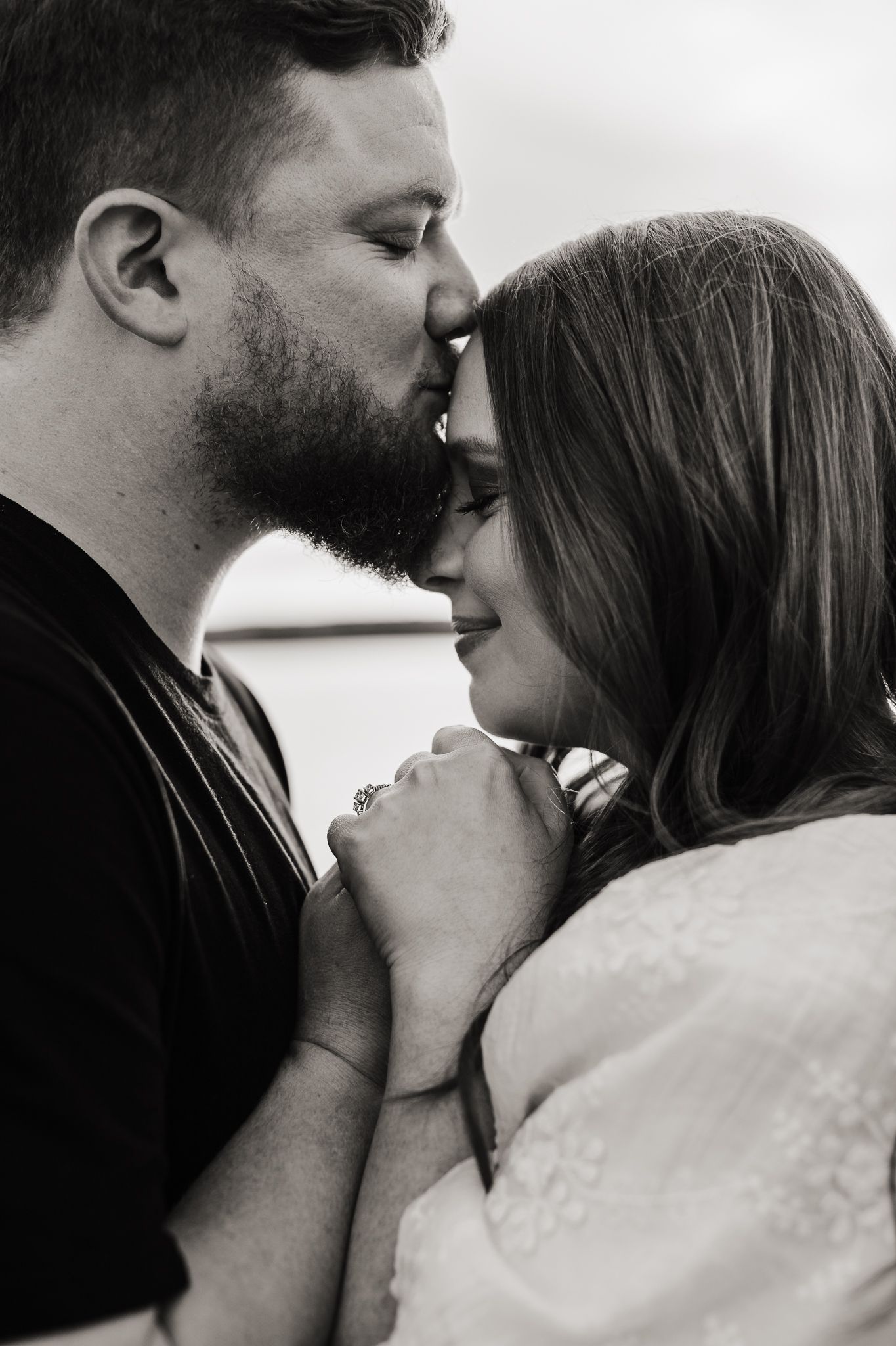 Intimate black and white portrait series of couple sharing tender moments.