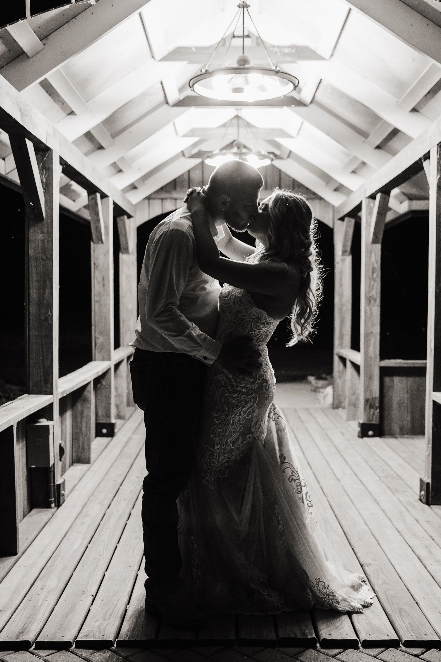 Dramatic black and white dance scene in a rustic white chapel with vaulted ceiling.