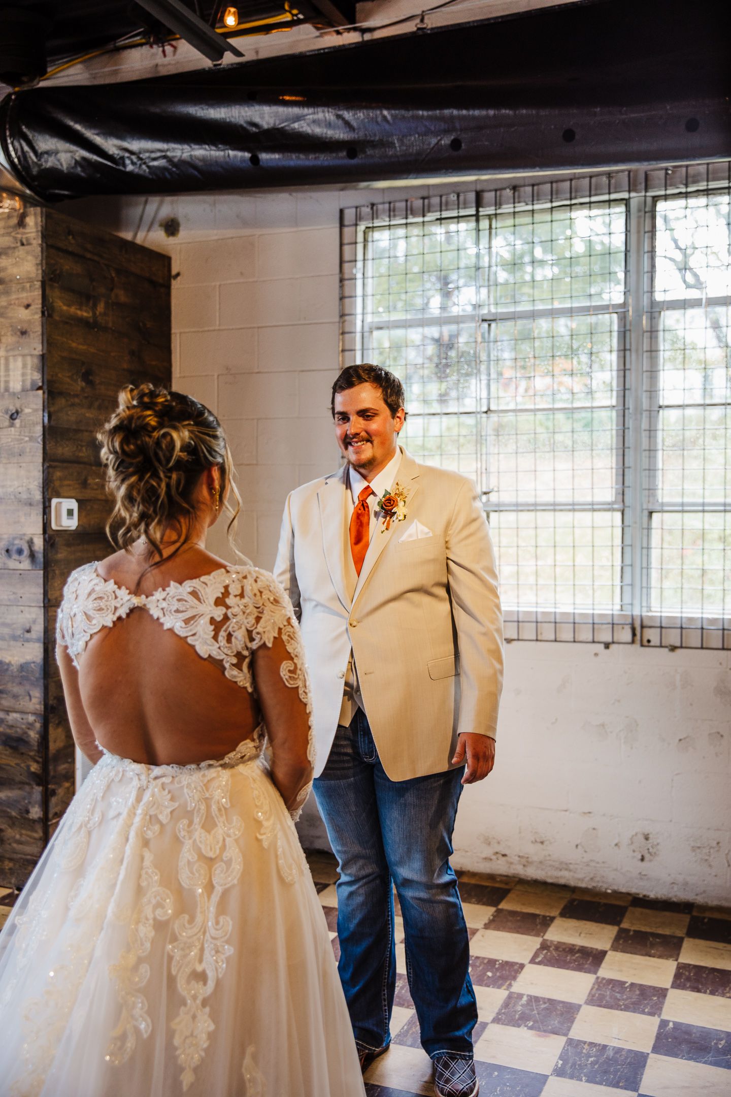 First look moment in an industrial venue with checkered flooring.