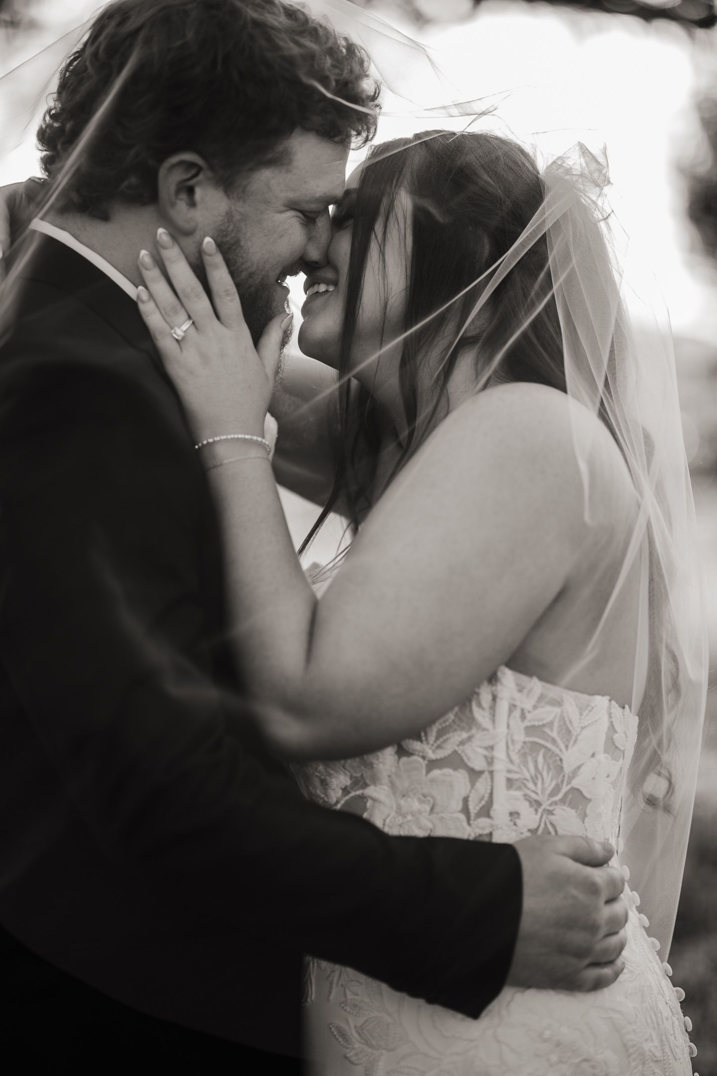 Intimate black and white wedding portraits with romantic veil details.