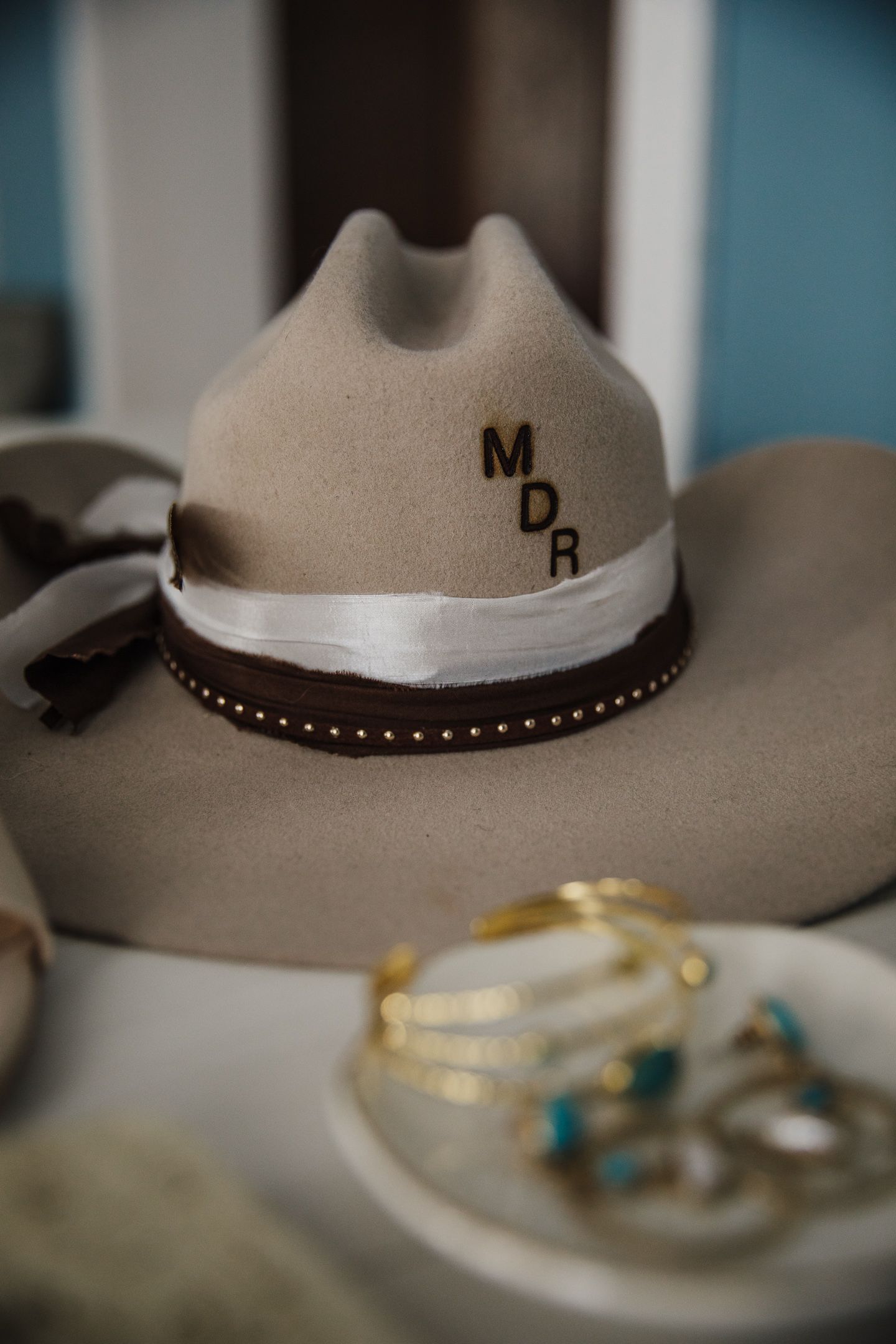 Western cowboy hats and turquoise jewelry arranged on a display surface.