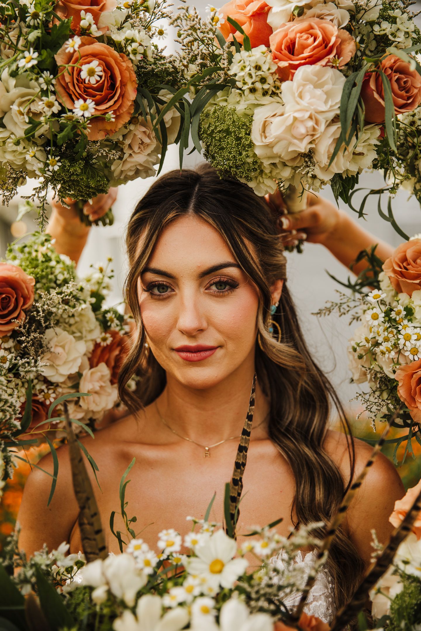 Floral wedding portrait series featuring romantic peach roses, daisies and greenery in a dreamy garden setting.