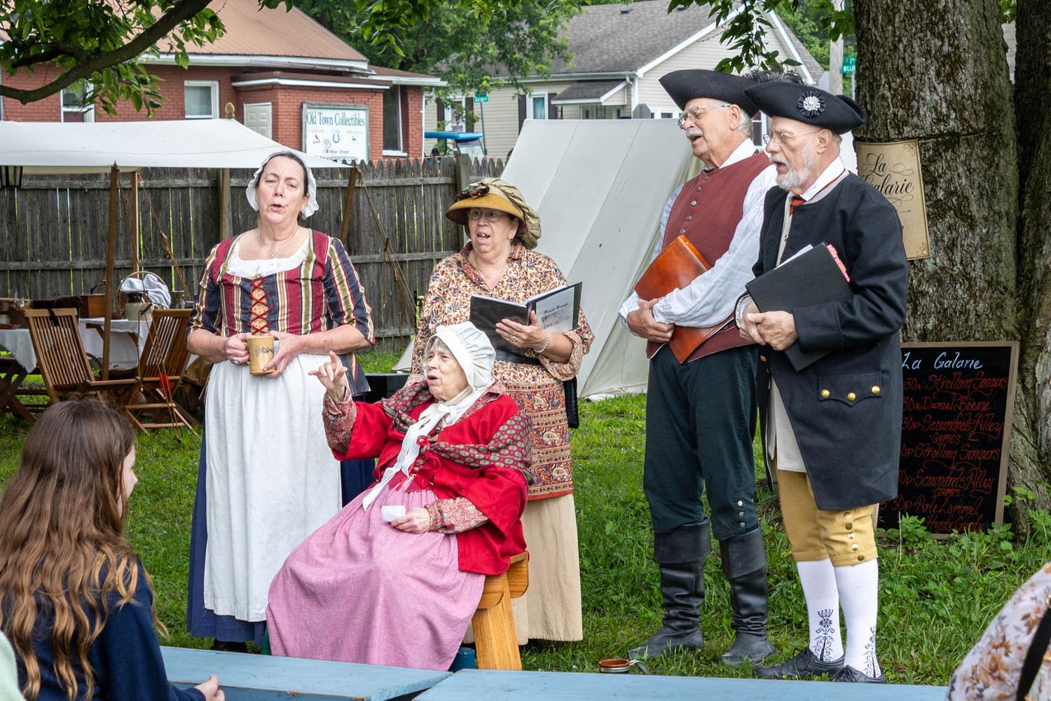 People in 18th-century colonial costumes perform at the Spirit of Vincennes Rendezvous historical reenactment outdoor event.